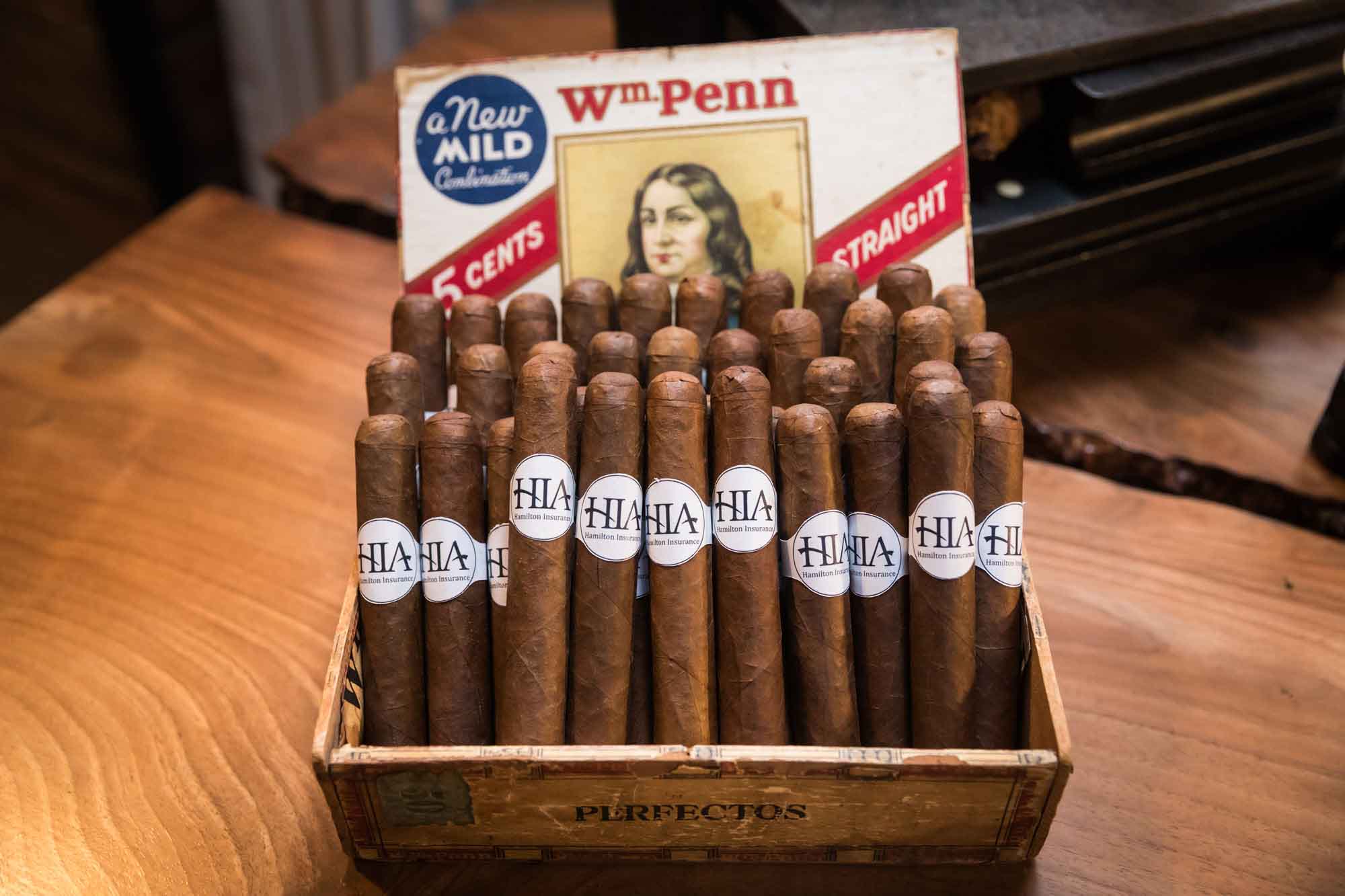 Close up of box of cigars with name of sponsors on cigar labels during a Hotel Van Zandt corporate event