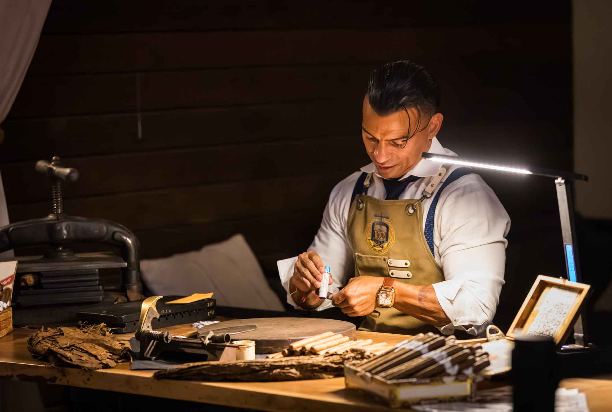 Ibrahim Ruiz preparing cigars during a Hotel Van Zandt corporate event