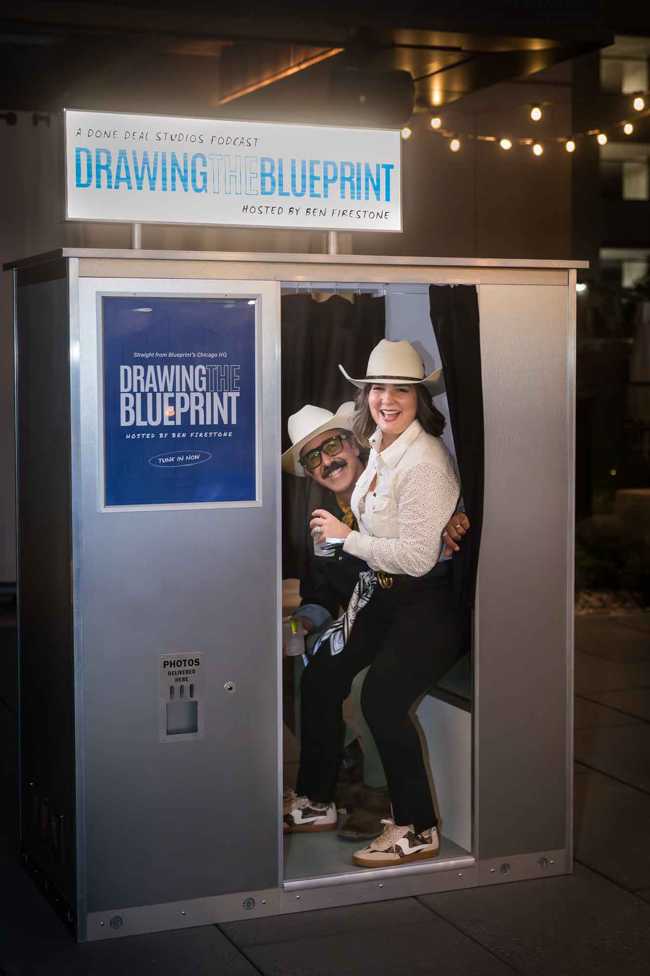 Couple smiling while seated in the photo booth during a Hotel Van Zandt corporate event