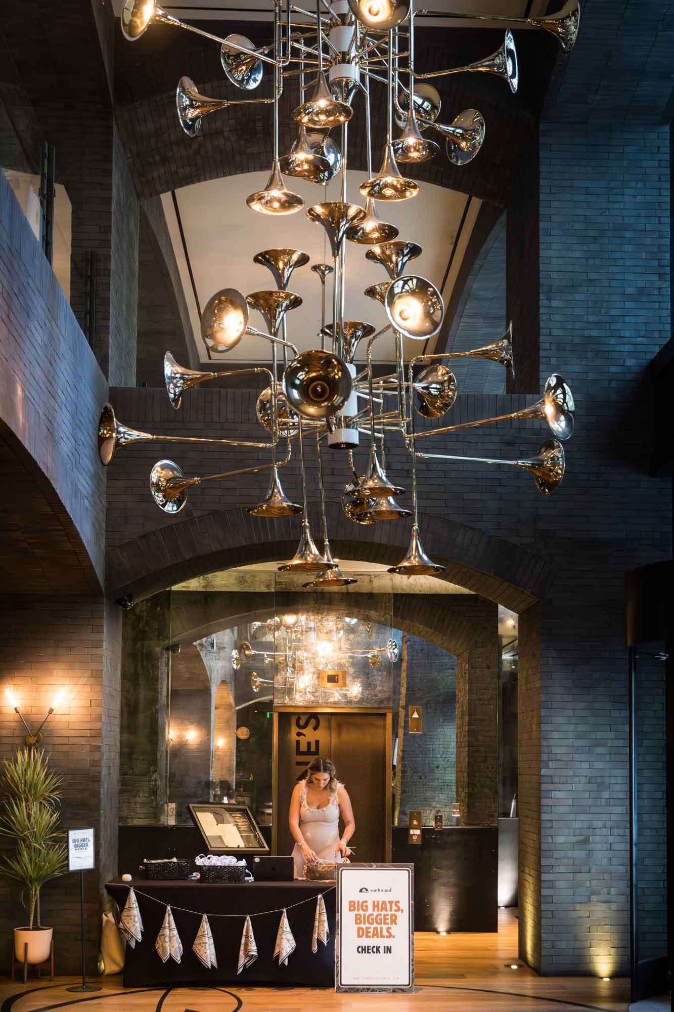 Registration desk and lights in the form of musical instruments in the lobby of the Hotel Van Zandt during a Hotel Van Zandt corporate event