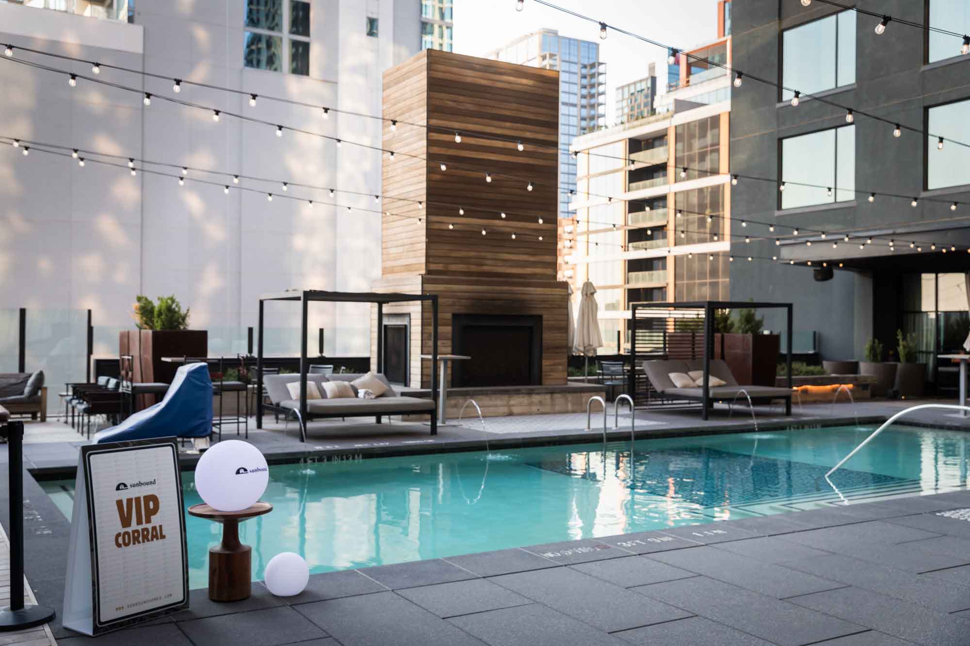 Pool deck with sponsor signage during a Hotel Van Zandt corporate event