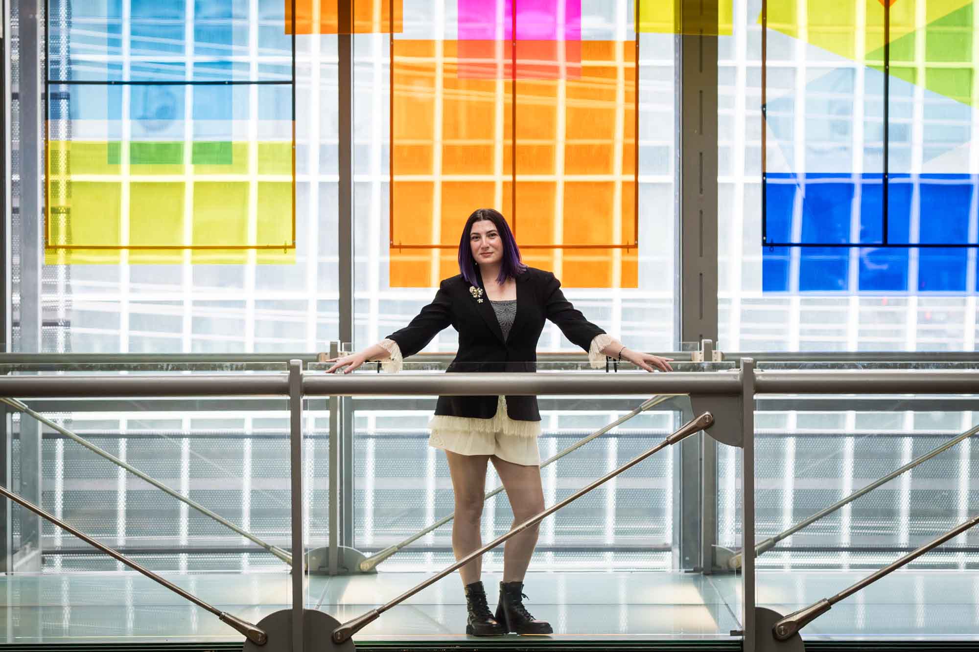 Author Nancy Knight standing n front of an art installation for an article on how to take photos in the Austin Central Library
