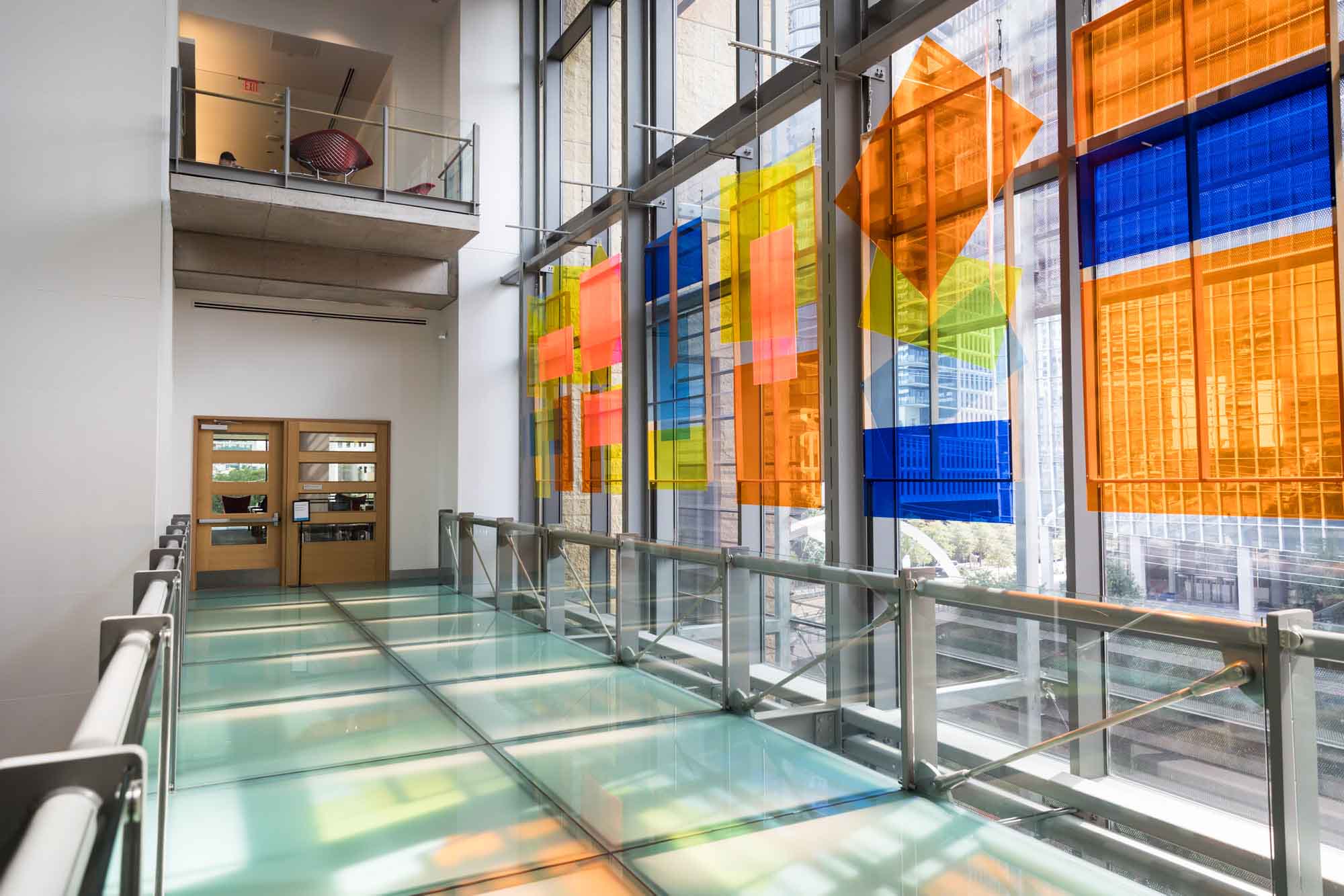 Glass and metal walkway in front of 'If a Tree Falls...' permanent art installation by artist Susan Scafati in the Austin Central Library