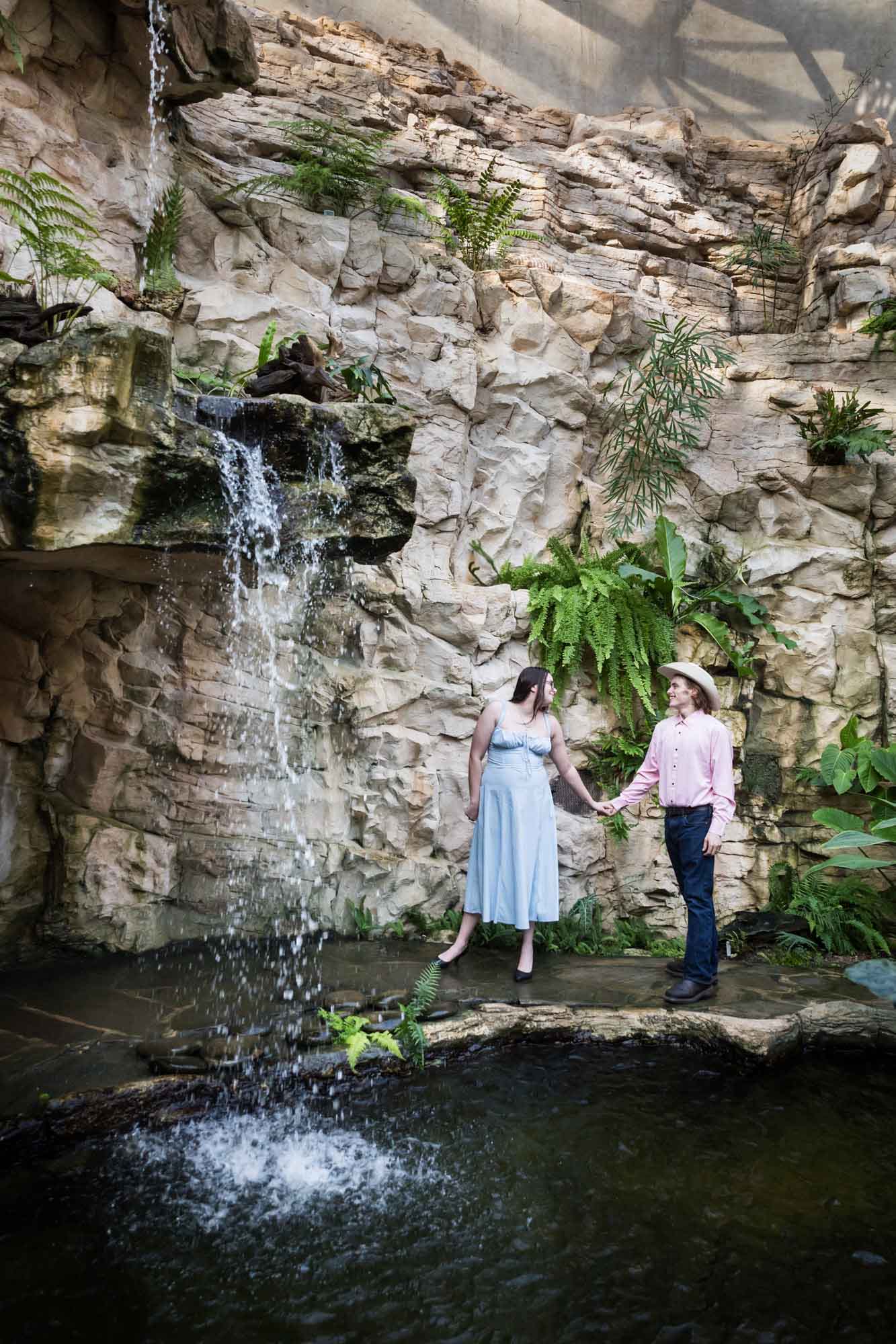 San Antonio Botanical Garden engagement photos of couple holding hands in fern grotto
