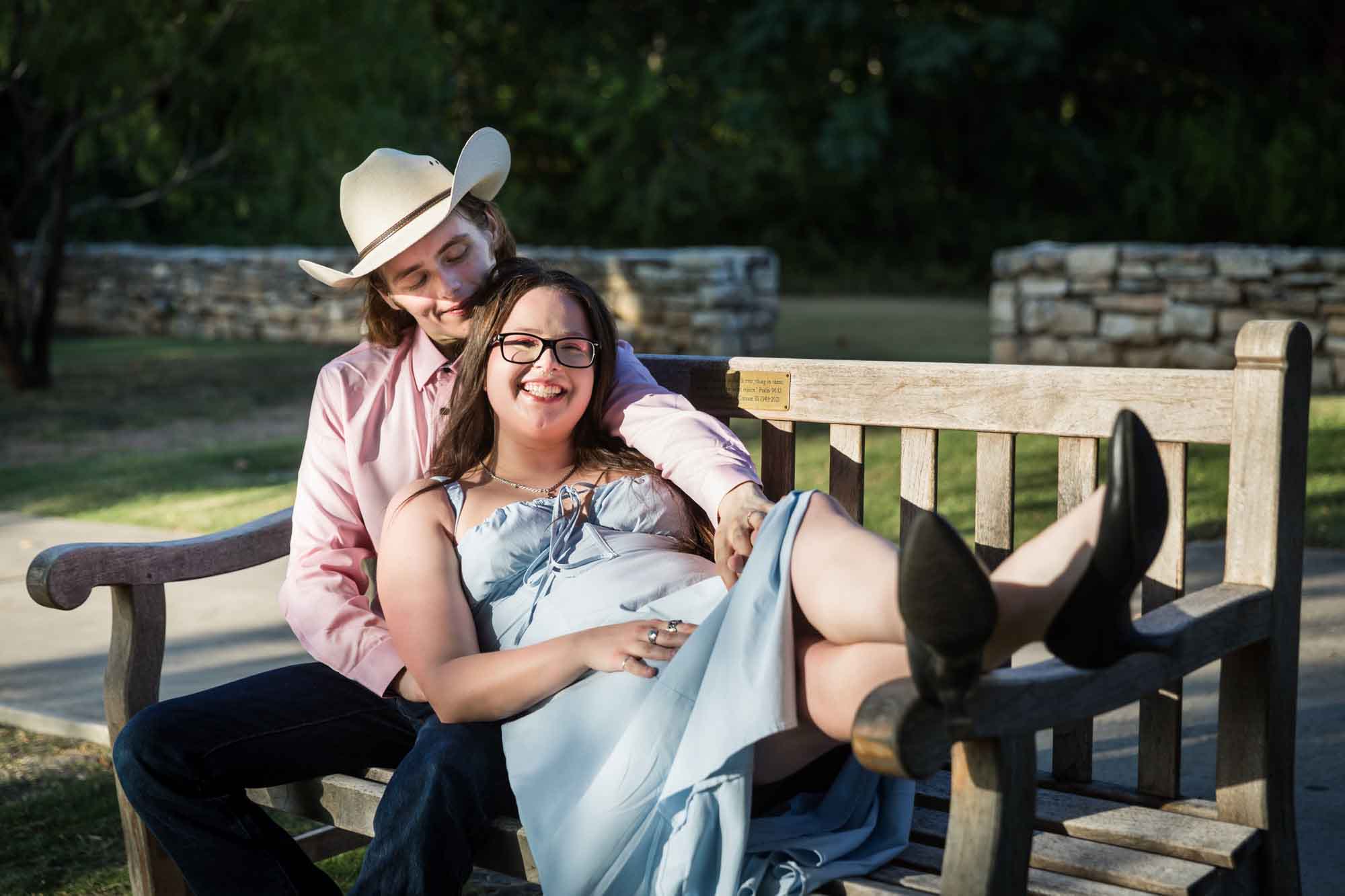 San Antonio Botanical Garden engagement photos of couple laying on bench at the Overlook