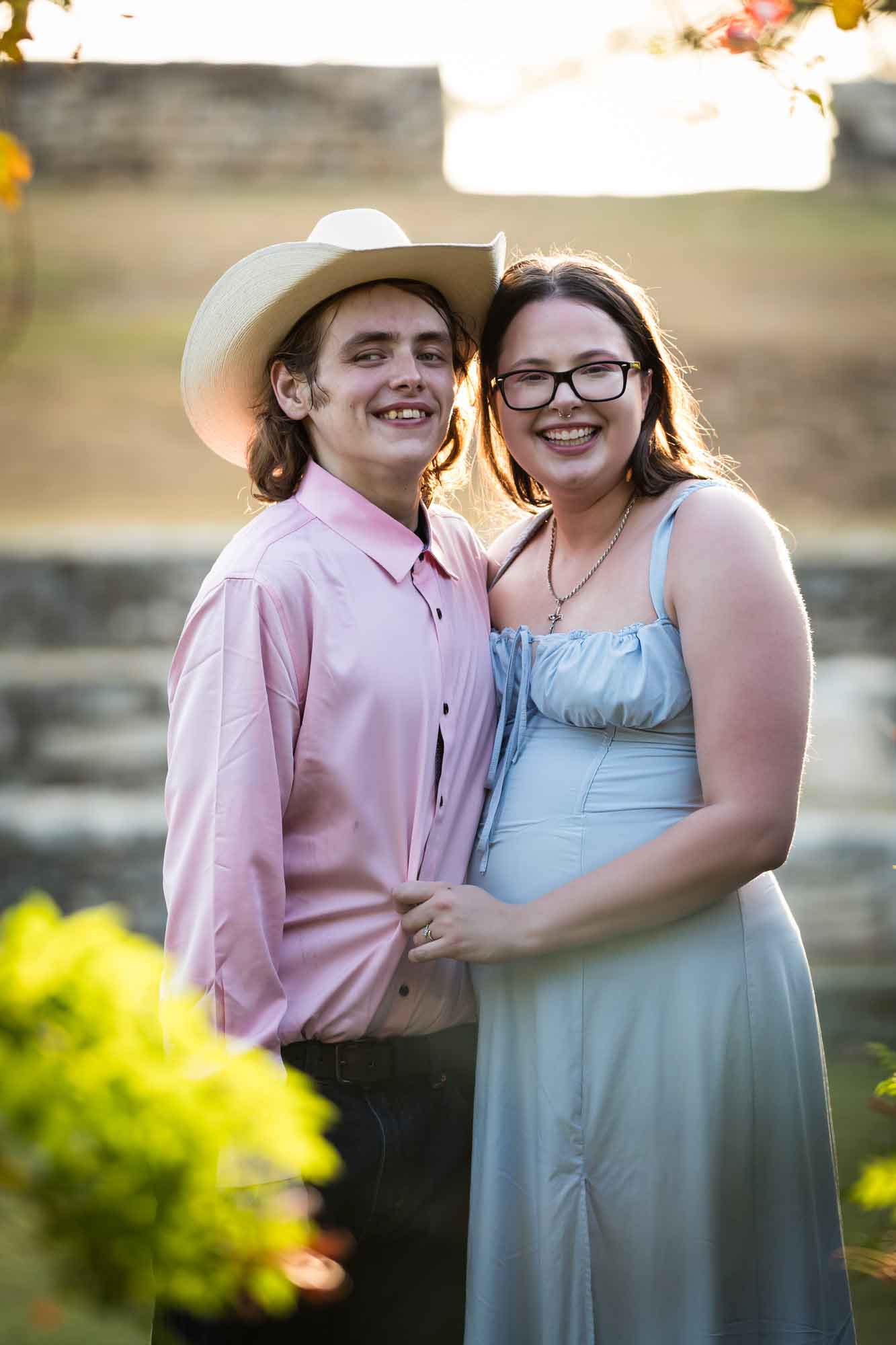 San Antonio Botanical Garden engagement photos of couple standing in front of vines at the Amphitheater