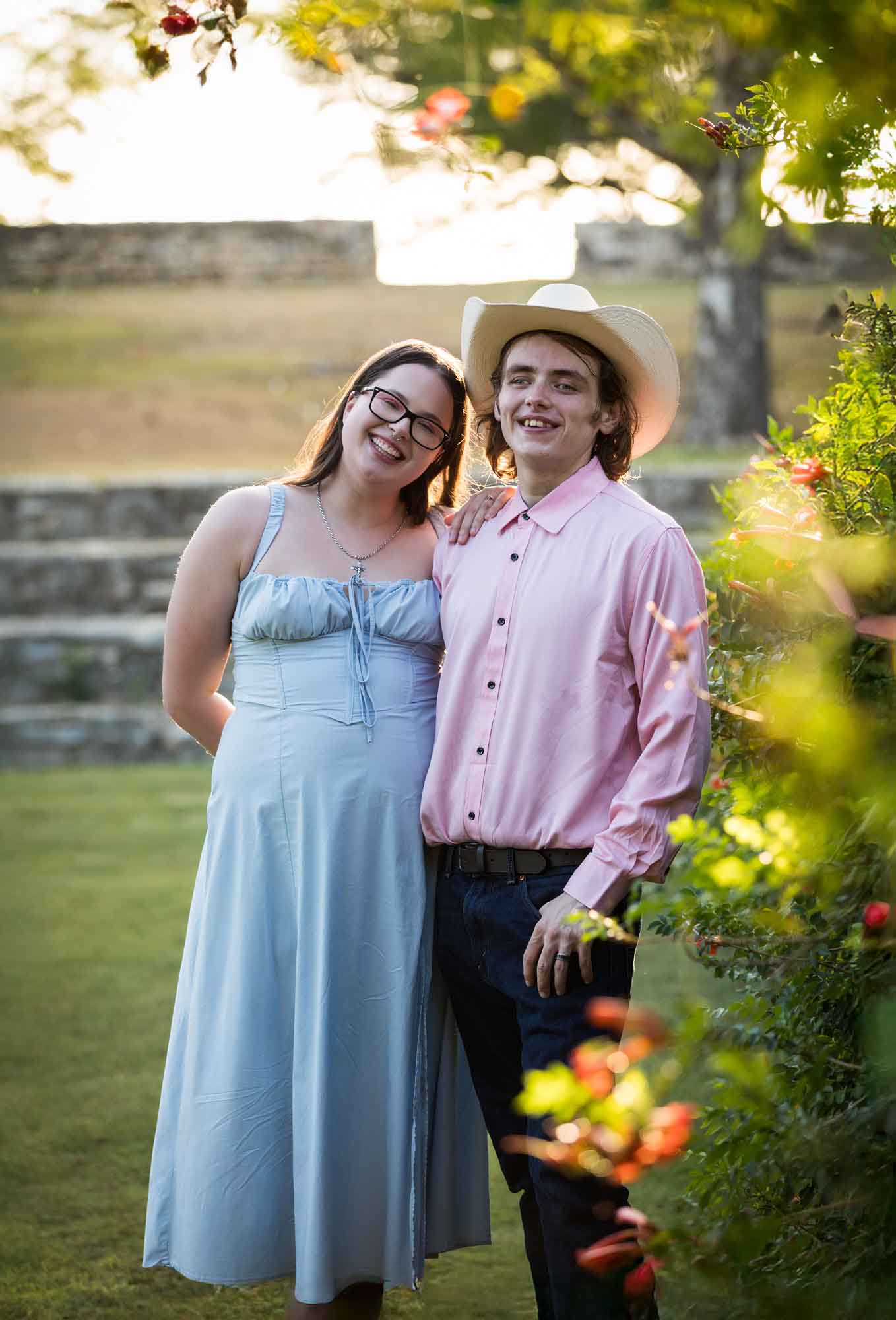 San Antonio Botanical Garden engagement photos of couple standing in front of vines at the Amphitheater