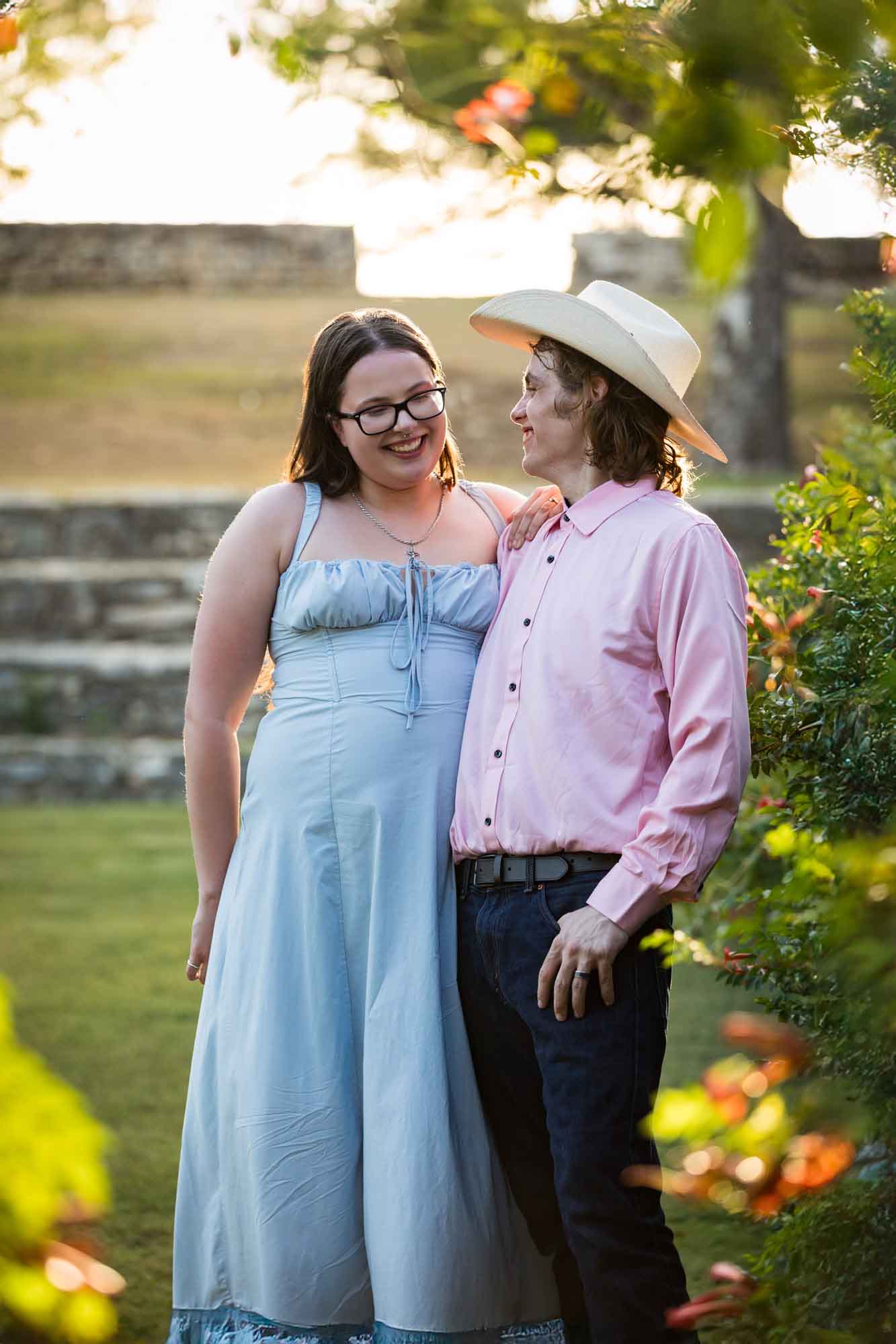 San Antonio Botanical Garden engagement photos of couple standing in front of vines at the Amphitheater