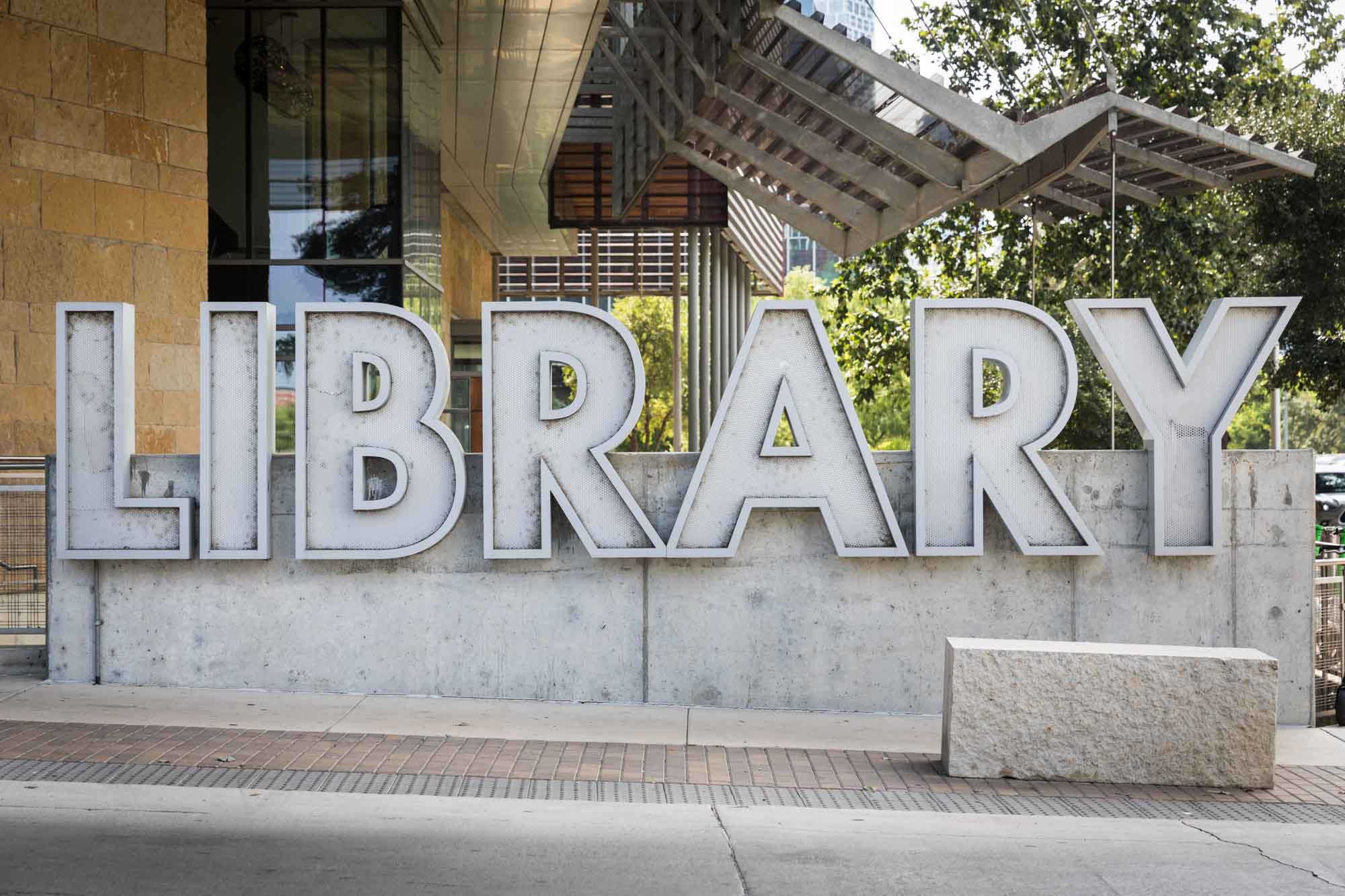 Large stone sign saying 'Library' outside the Austin Central Library for an article on the best places to propose in Austin