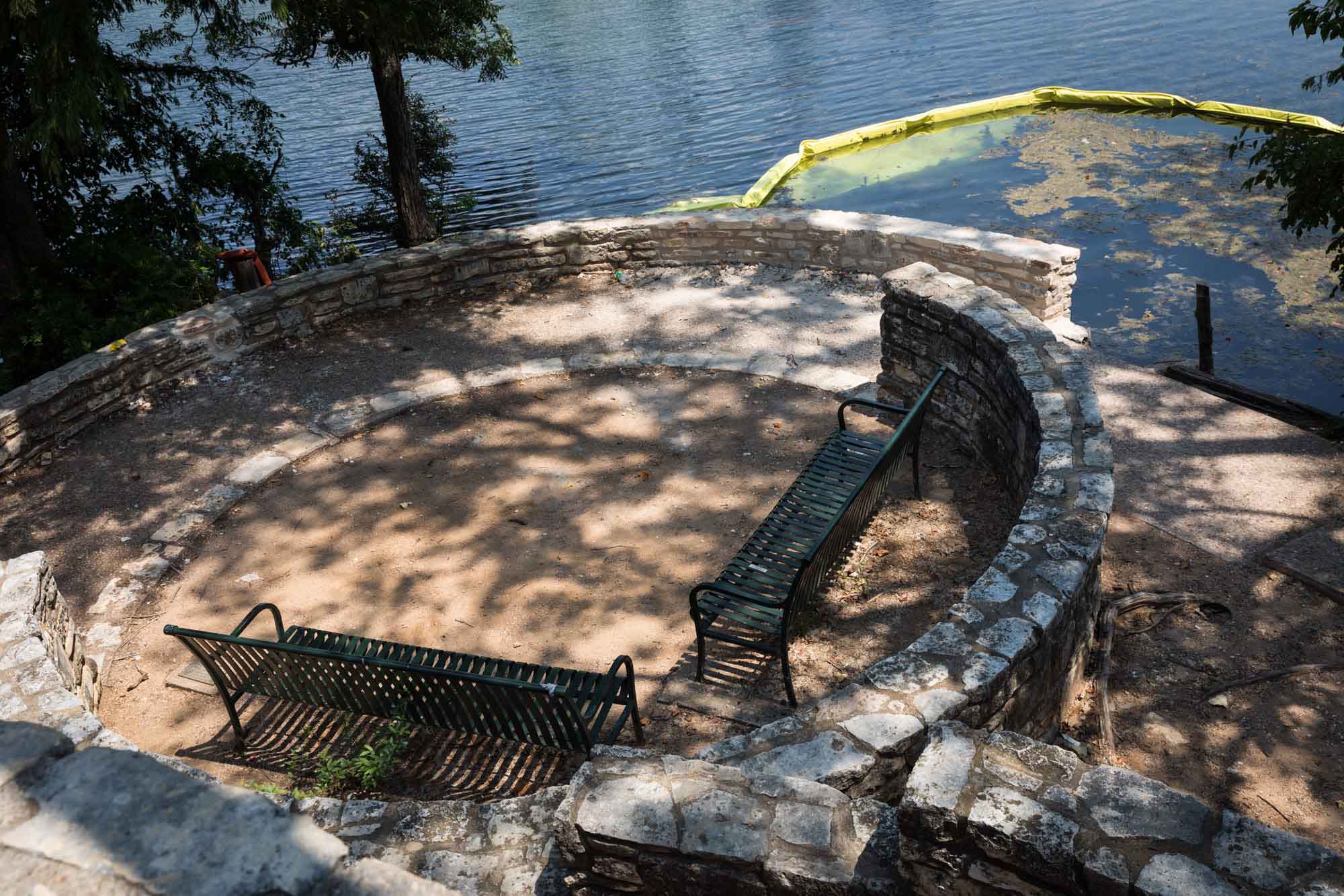 Two black benches and broken stone wall at Lou Neff Point for an article on the best places to propose in Austin