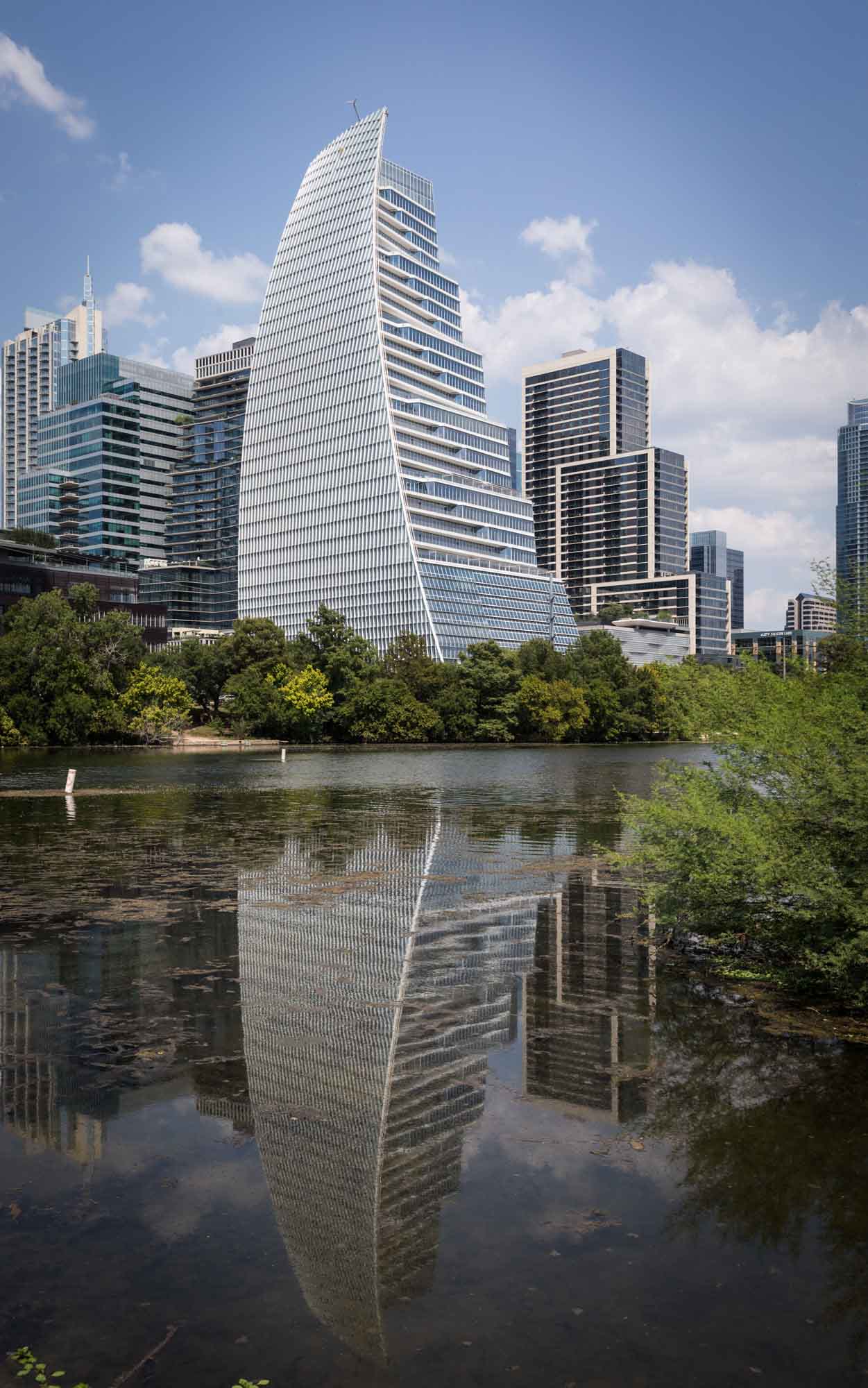 View of Block 185 building with reflection in the Colorado River for an article on the best places to propose in Austin