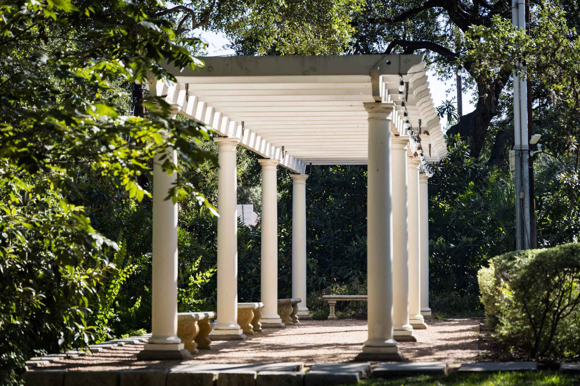 White colonnade in garden at Laguna Glorida for an article on the best places to propose in Austin