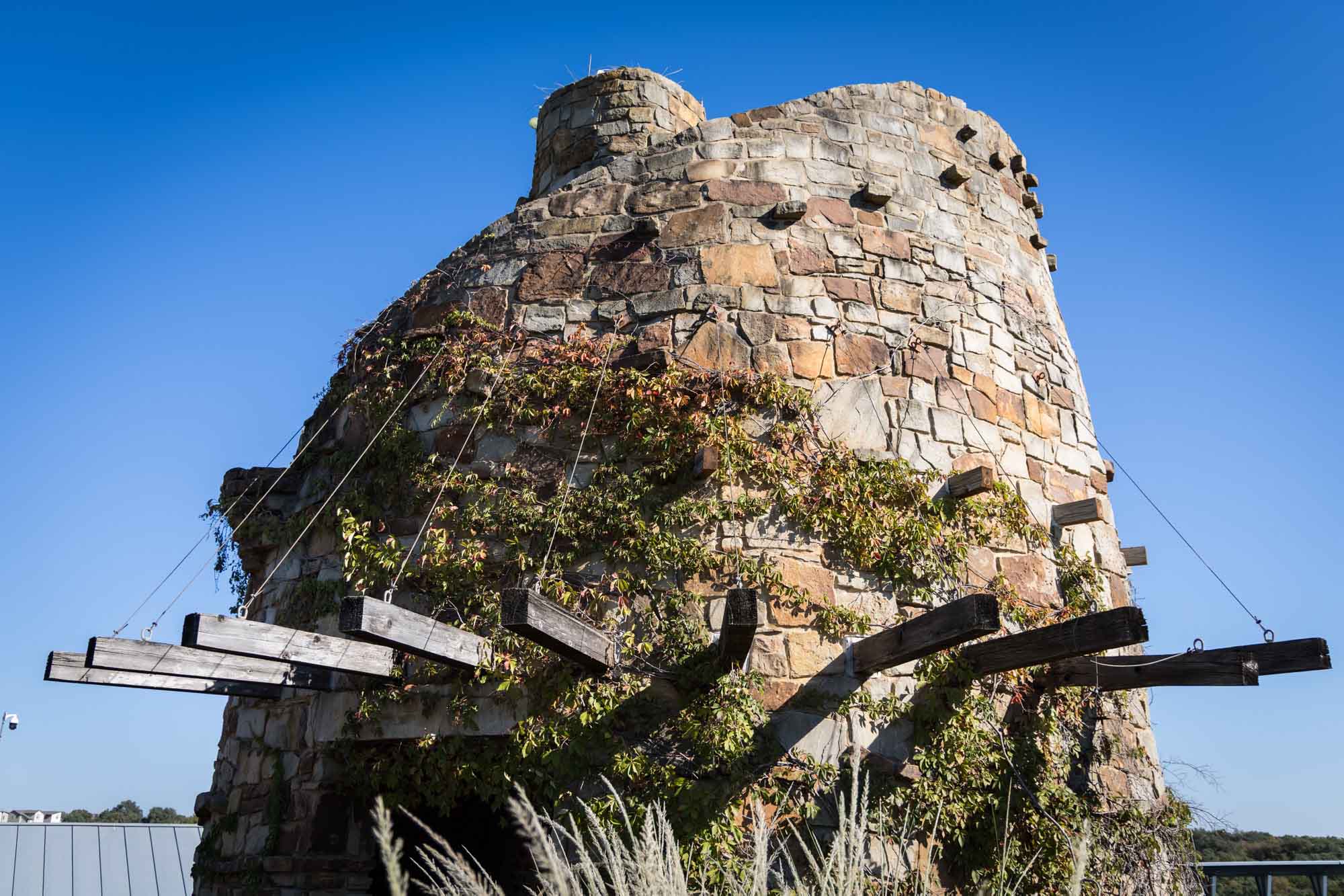 Stone tower with wooden planks sticking out at the Lady Bird Johnson Wildflower Center for an article on the best places to propose in Austin