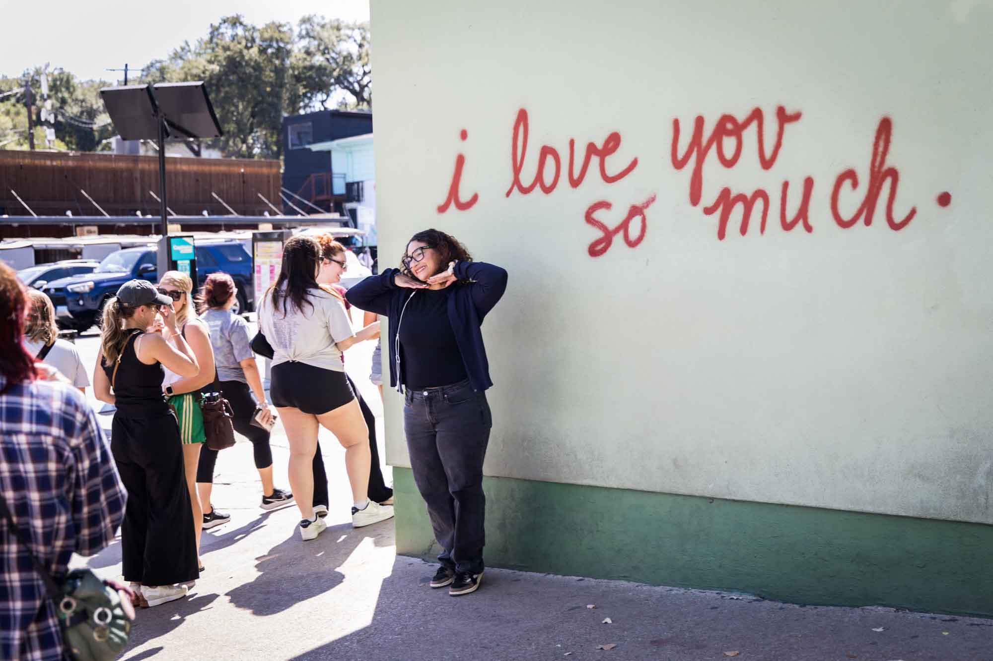 Girl posing in front of the I Love You So Much mural for an article on the best places to propose in Austin