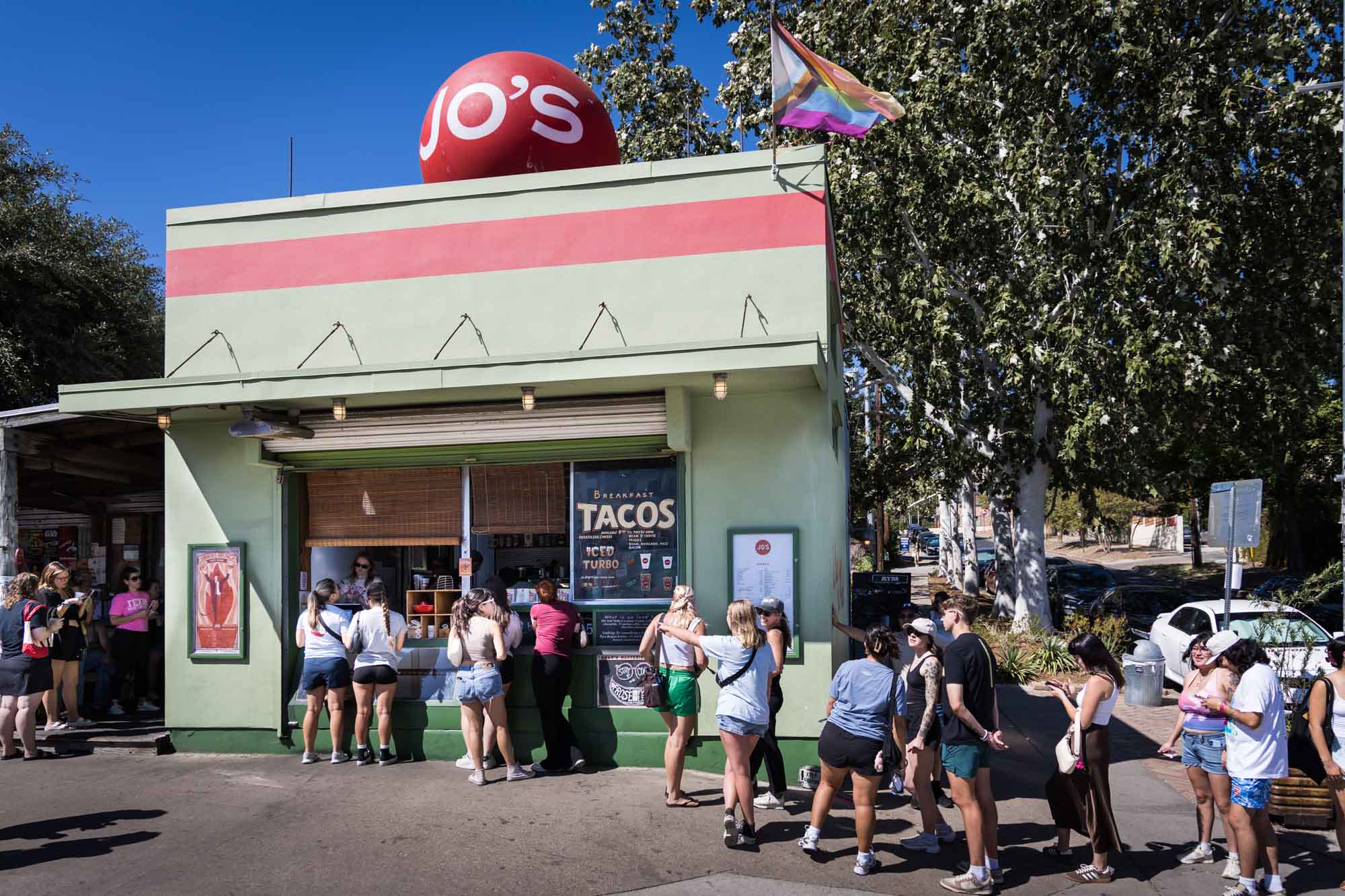 People lined up to buy food at Jo's Coffee next door to the I Love you So Much mural for an article on the best places to propose in Austin
