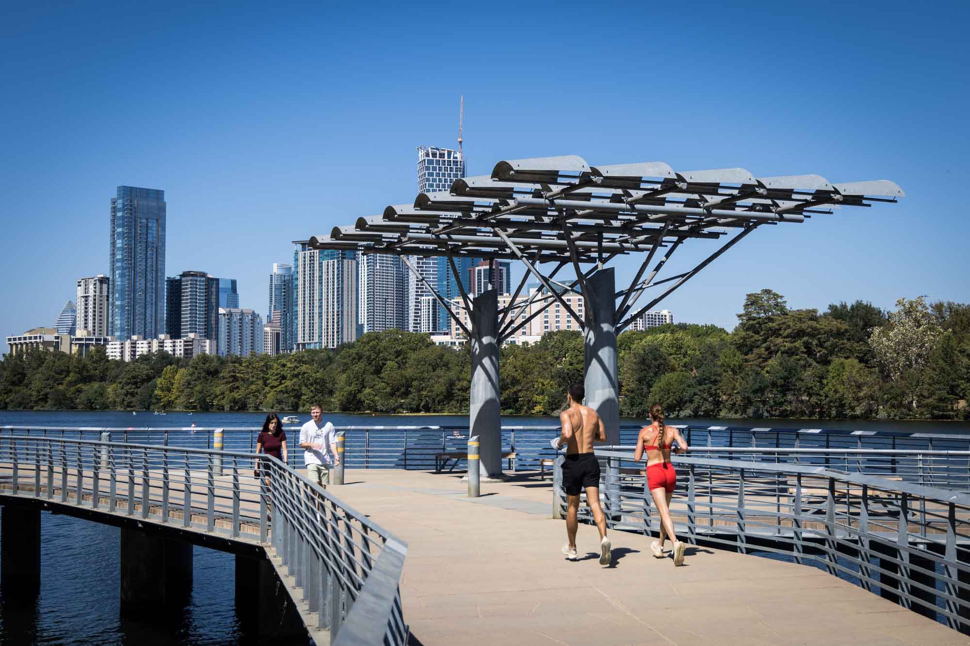 People walking and jogging on the Lady Bird Lake Boardwalk for an article on the best places to propose in Austin