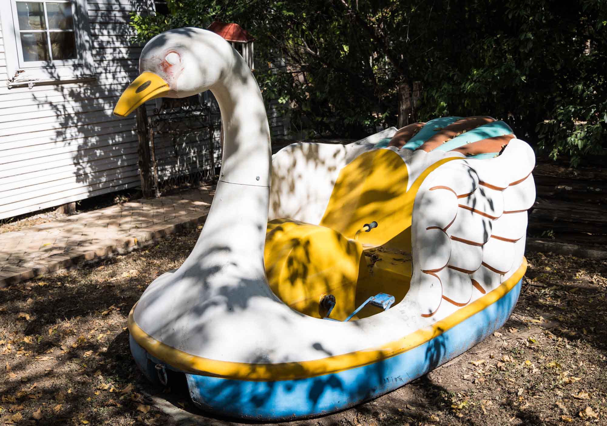 Vintage swan boat sitting in dirt in yard at Sekrit Theater for an article on the best places to propose in Austin