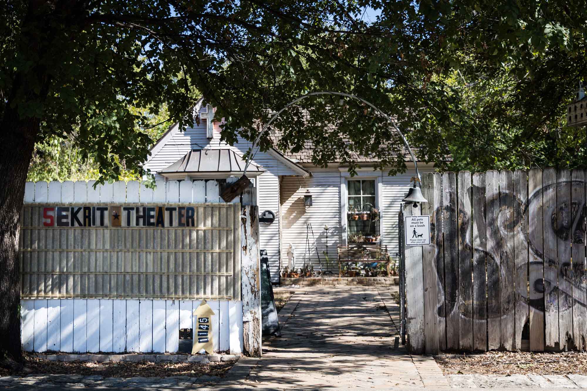 Entrance to the Sekrit Theater with white fence and house in background for an article on the best places to propose in Austin