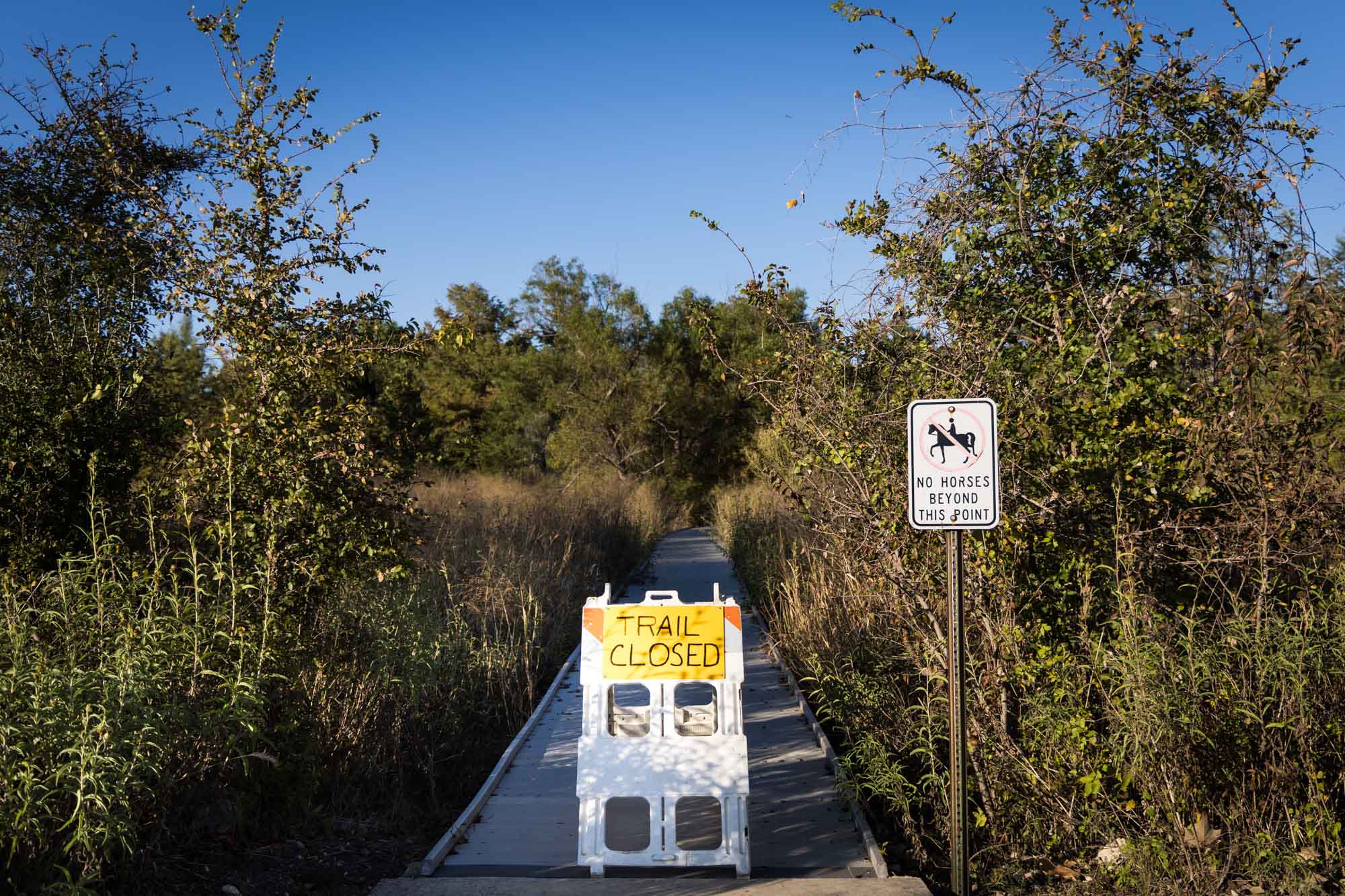 Sign saying 'Trail Closed' on marsh trail for an article on Cibolo Nature Center surprise proposal tips