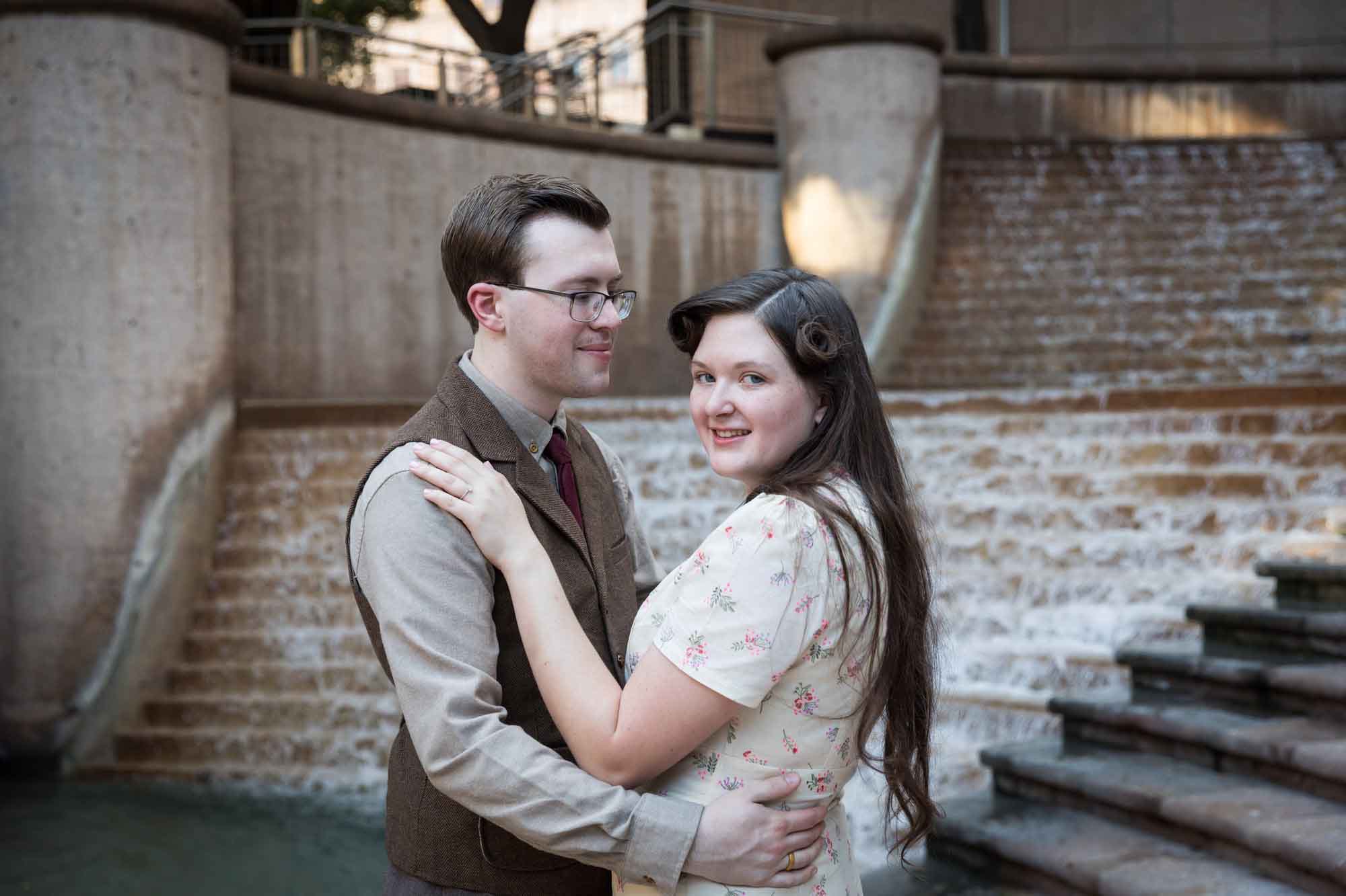 Couple dancing in front of waterfall and stairs at Weston Centre during a River Walk surprise proposal