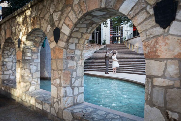 Couple dancing in front of waterfall and stairs at Weston Centre during a River Walk surprise proposal