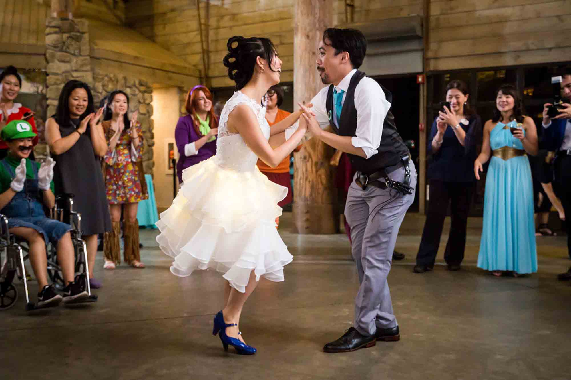 Bride and groom dancing in front of guests during reception for an article on unexpected wedding photo tips