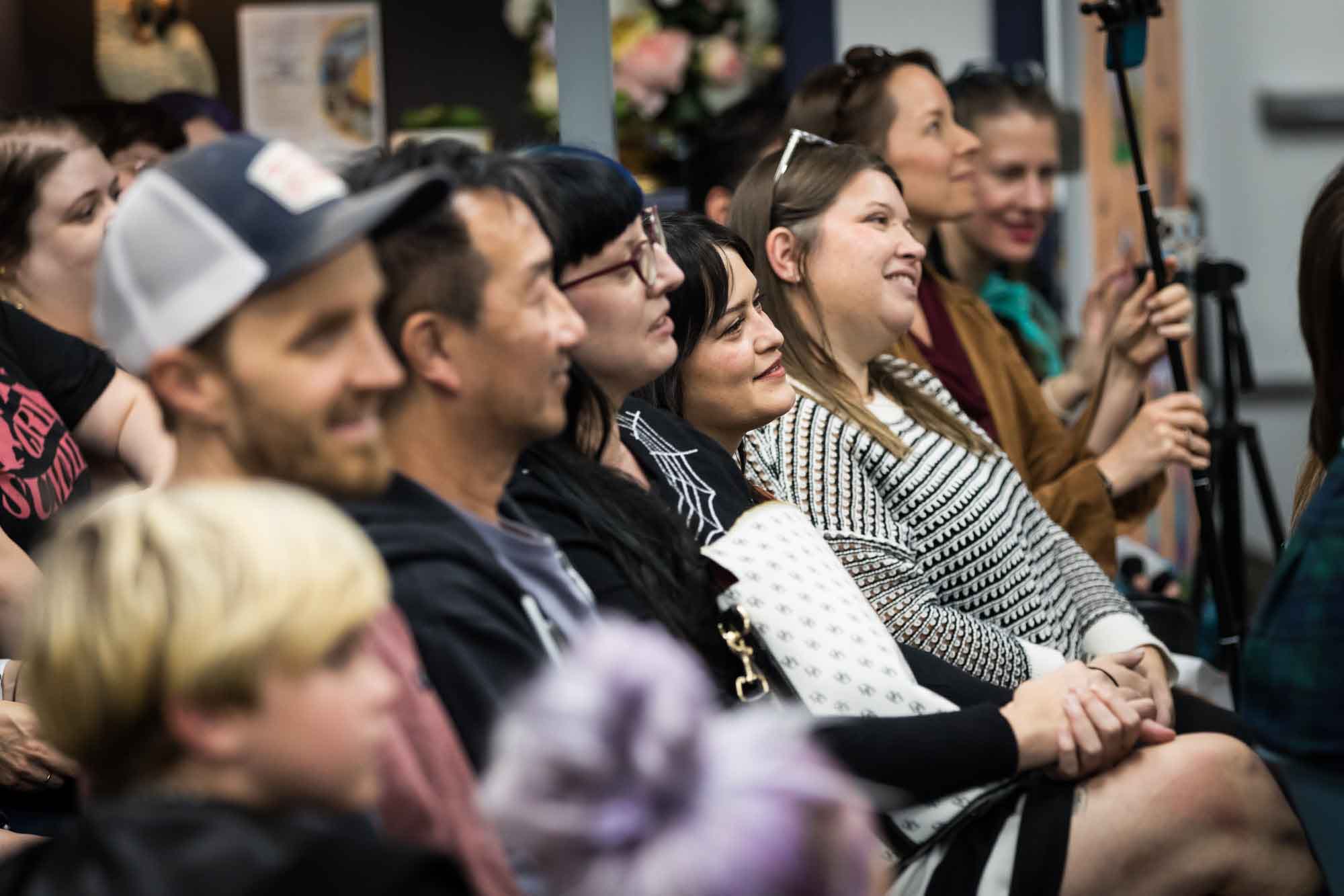Austin book launch party photos of guests seated and listening at Birdhouse Books