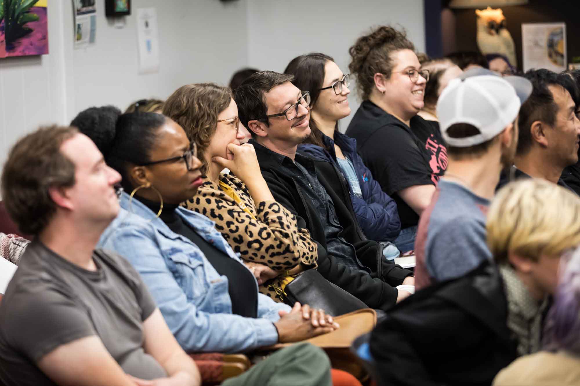 Austin book launch party photos of guests seated and listening at Birdhouse Books