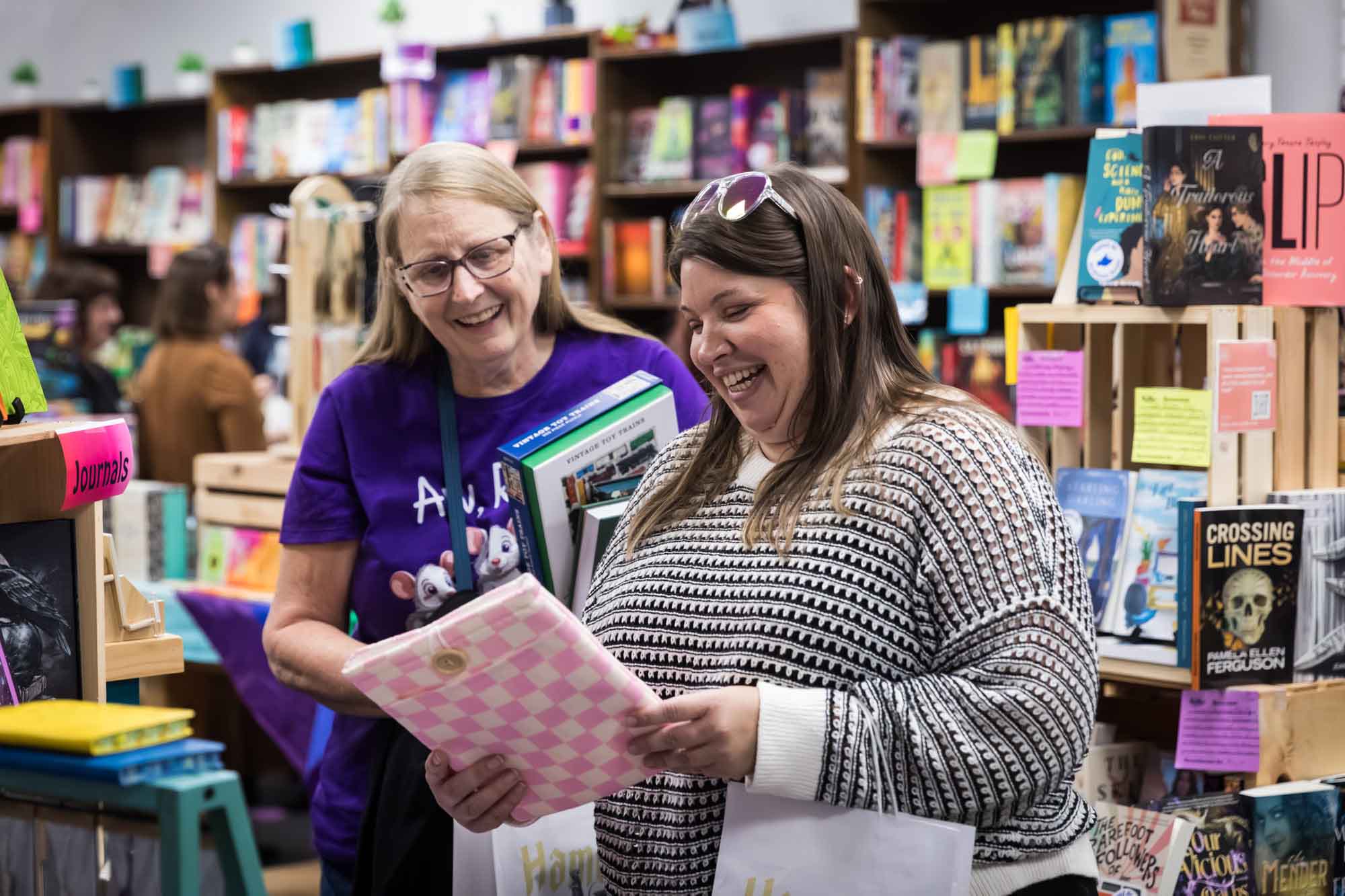 Austin book launch party photos of two women looking at fabric laptop covers at Birdhouse Books