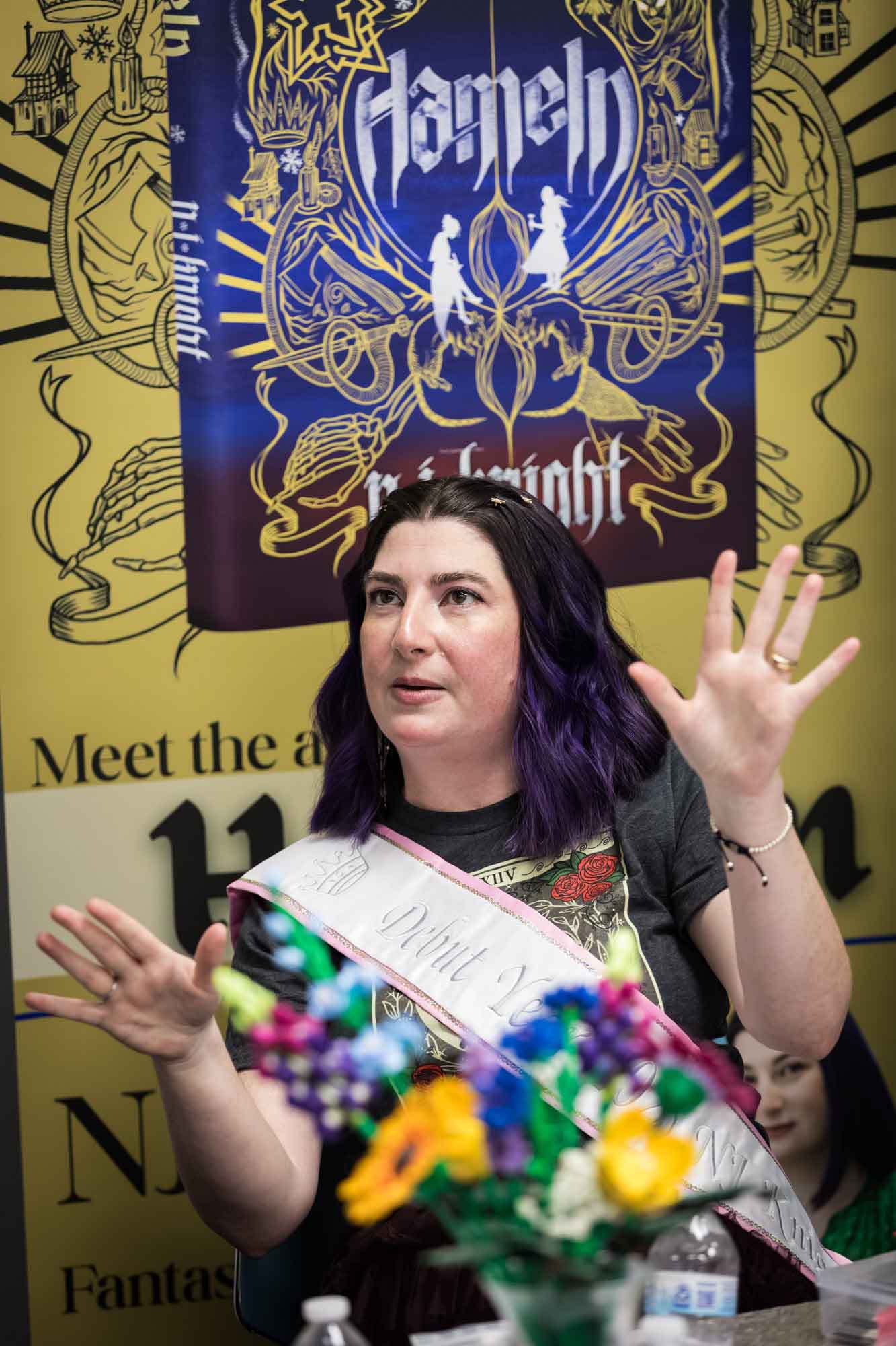 Austin book launch party photos of author Nancy Knight in front of signage announcing her book Hameln