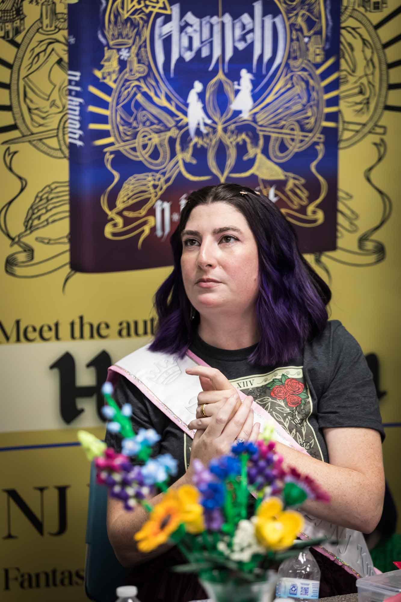 Austin book launch party photos of author Nancy Knight in front of signage announcing her book Hameln