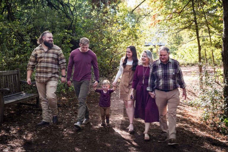 San Antonio Botanical Gardens family portrait of family walking in forest consisting of grandparents, adult brother, and mother and father holding hands of little boy