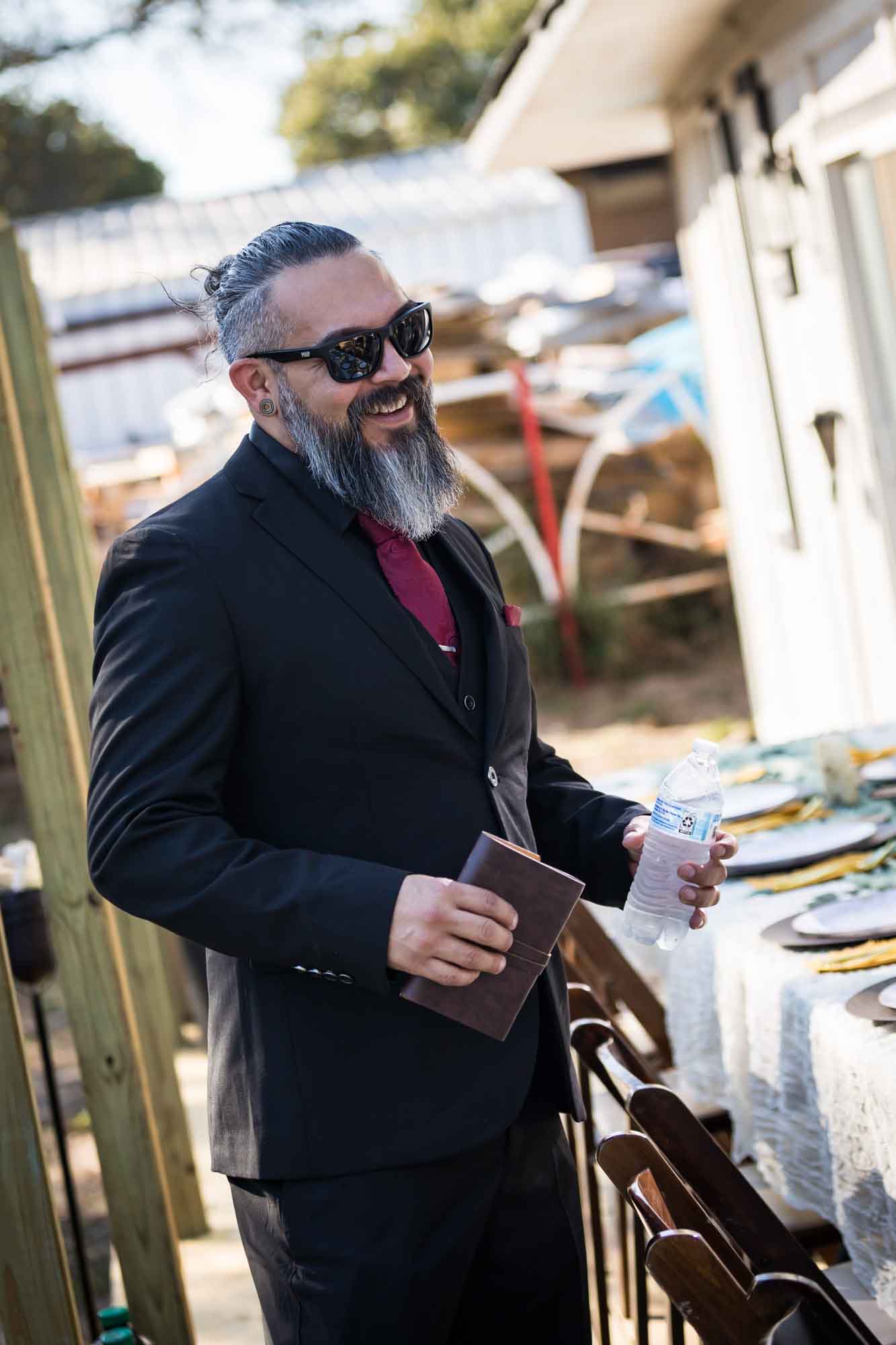 Man wearing black suit and sunglasses laughing at a San Antonio DIY wedding