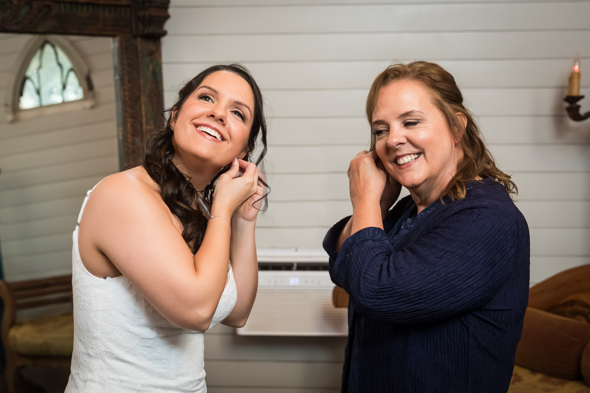 Bride and mother putting in earrings in bridal suite at a Chapel Dulcinea wedding