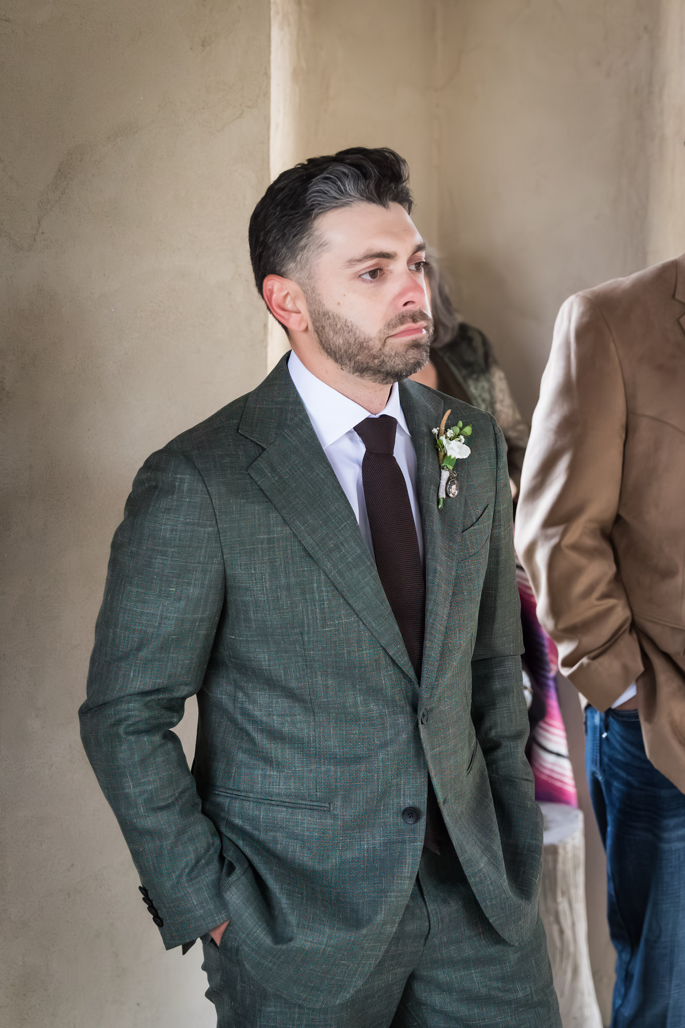 Groom wearing grey jacket waiting for bride during ceremony at a Chapel Dulcinea wedding