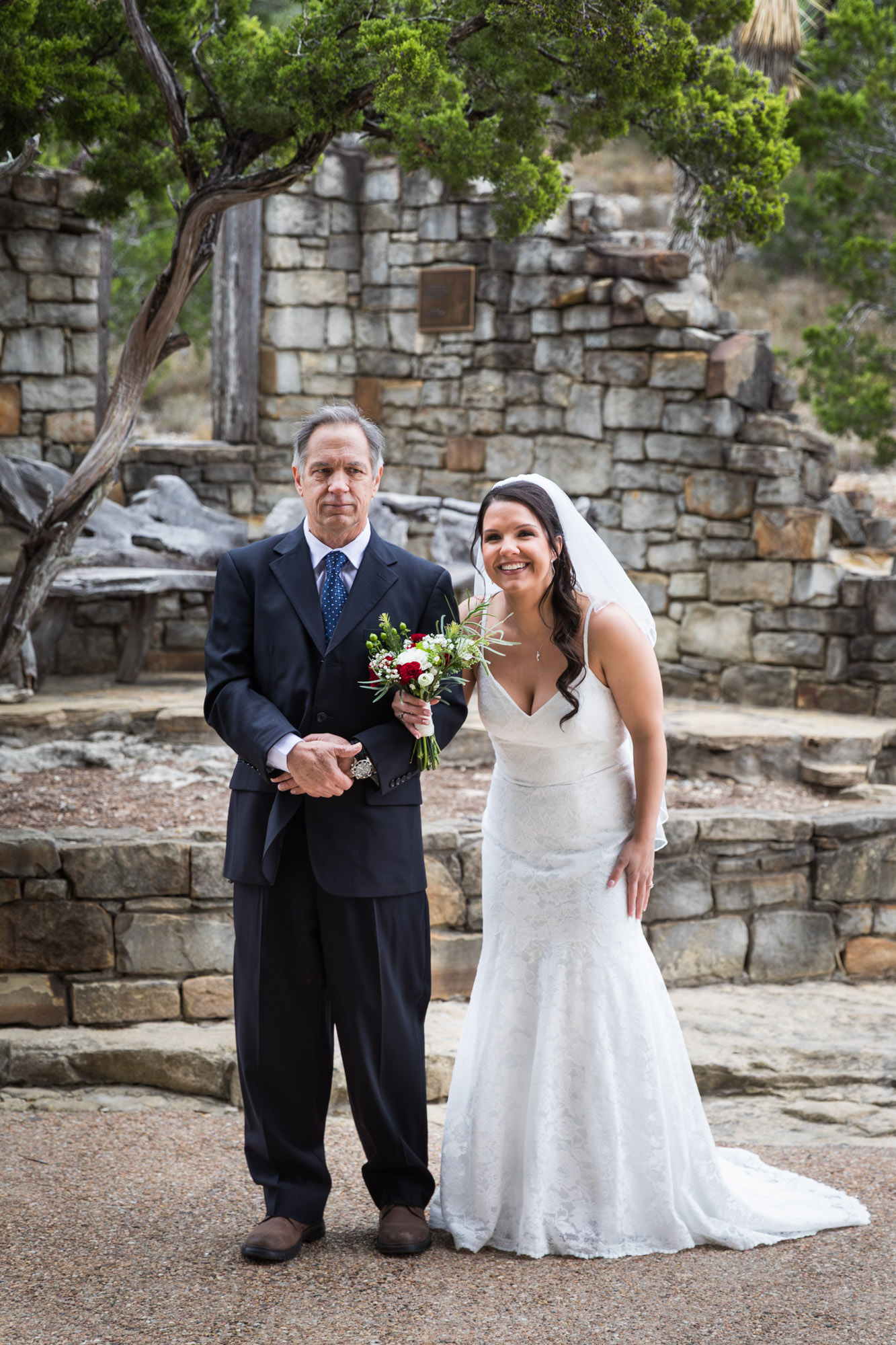Father walking bride wearing veil down aisle during ceremony at a Chapel Dulcinea wedding