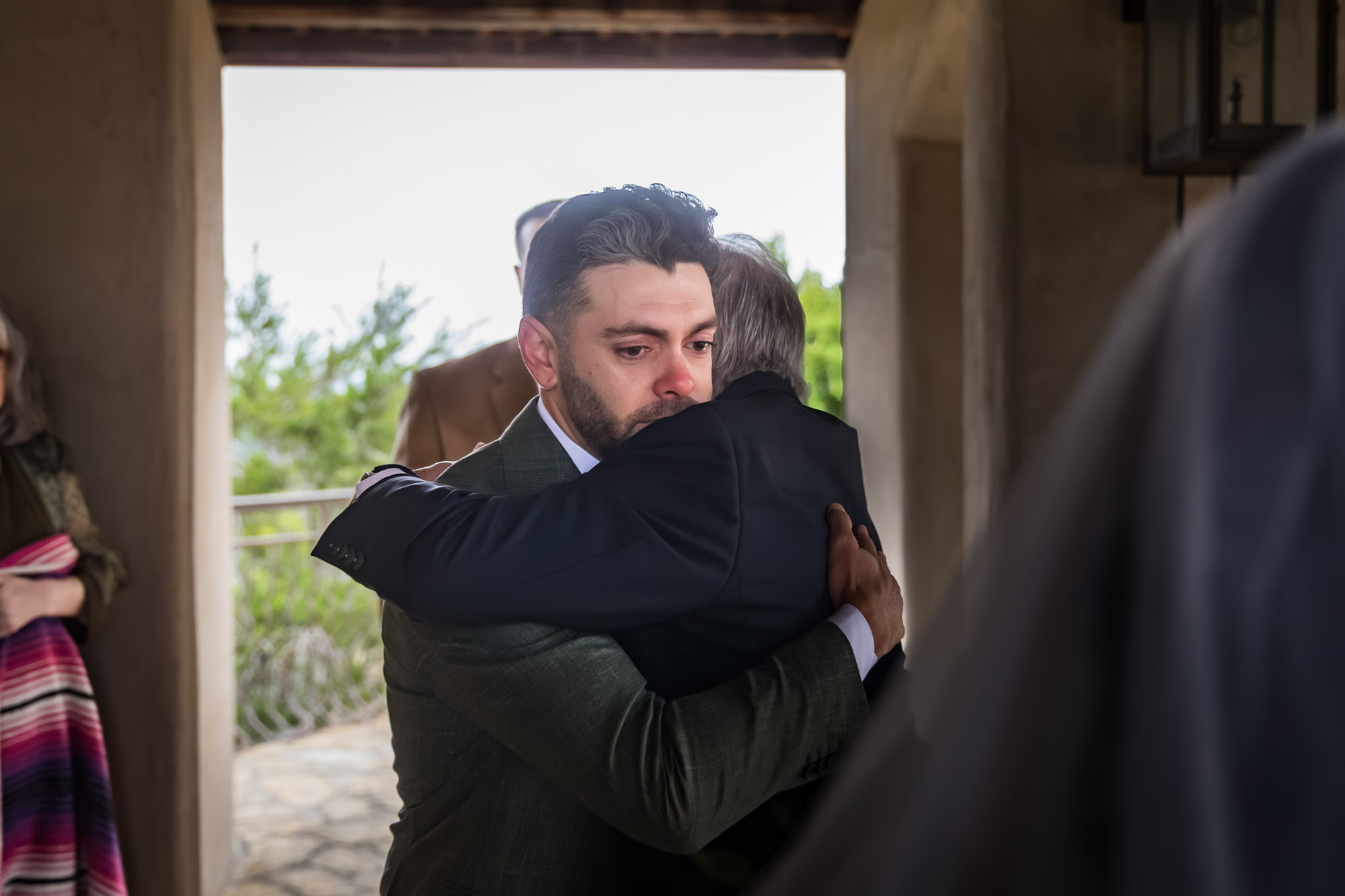 Groom hugging officiant during ceremony at a Chapel Dulcinea wedding