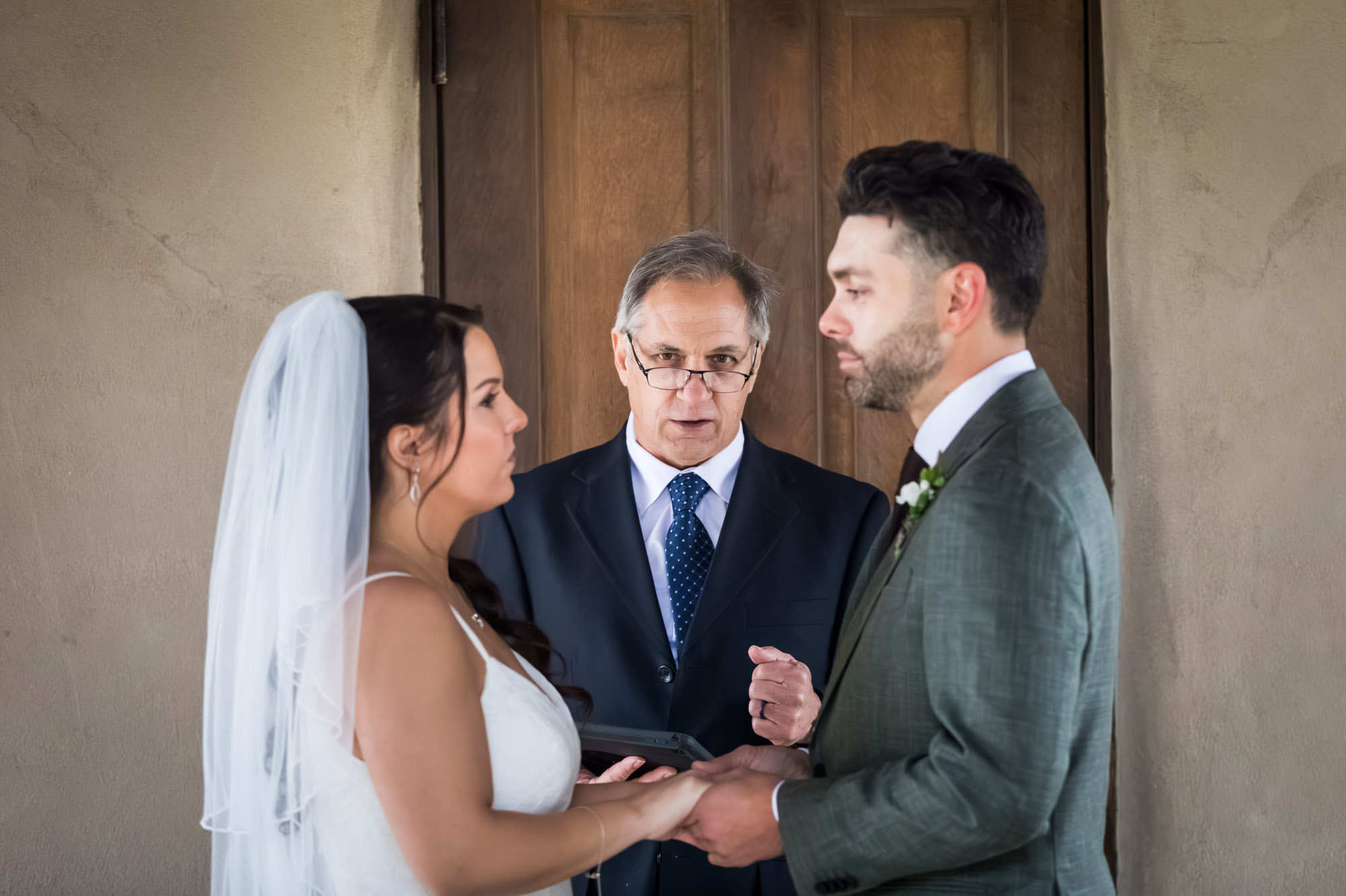 Bride and groom saying vows during ceremony at a Chapel Dulcinea wedding