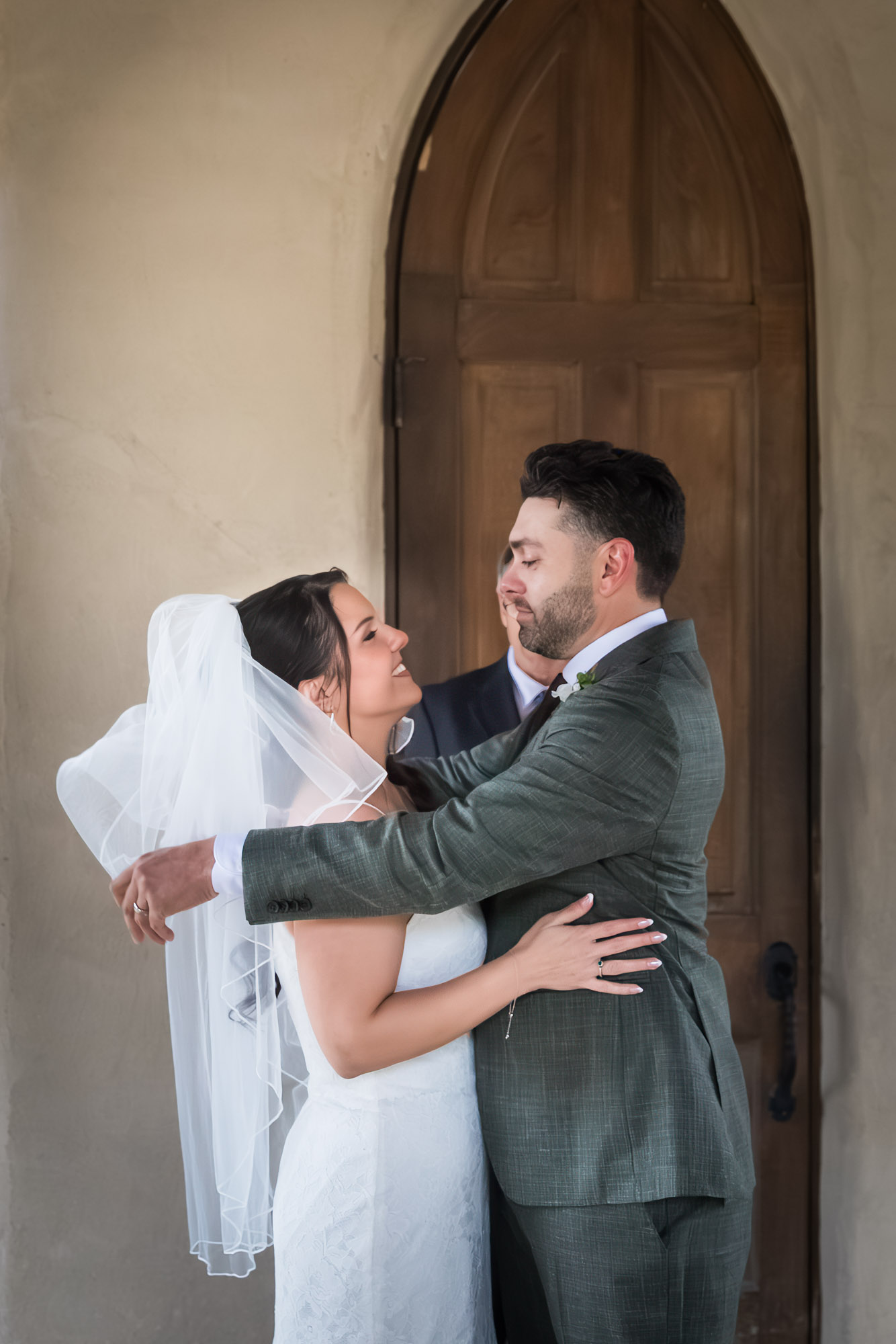 Groom pulling back bride's veil during ceremony at a Chapel Dulcinea wedding