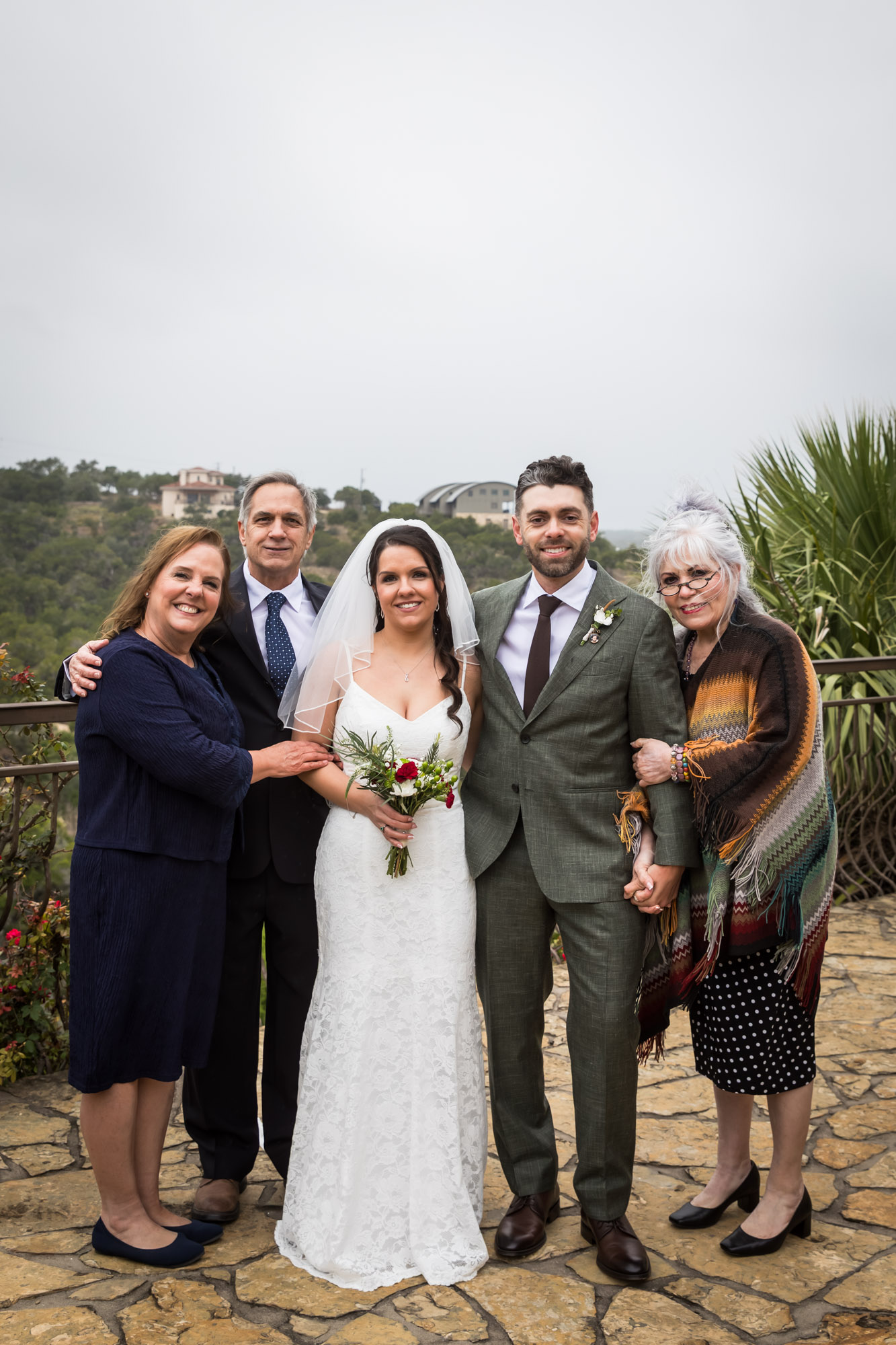 Bride and groom standing with family on outdoor patio at a Chapel Dulcinea wedding