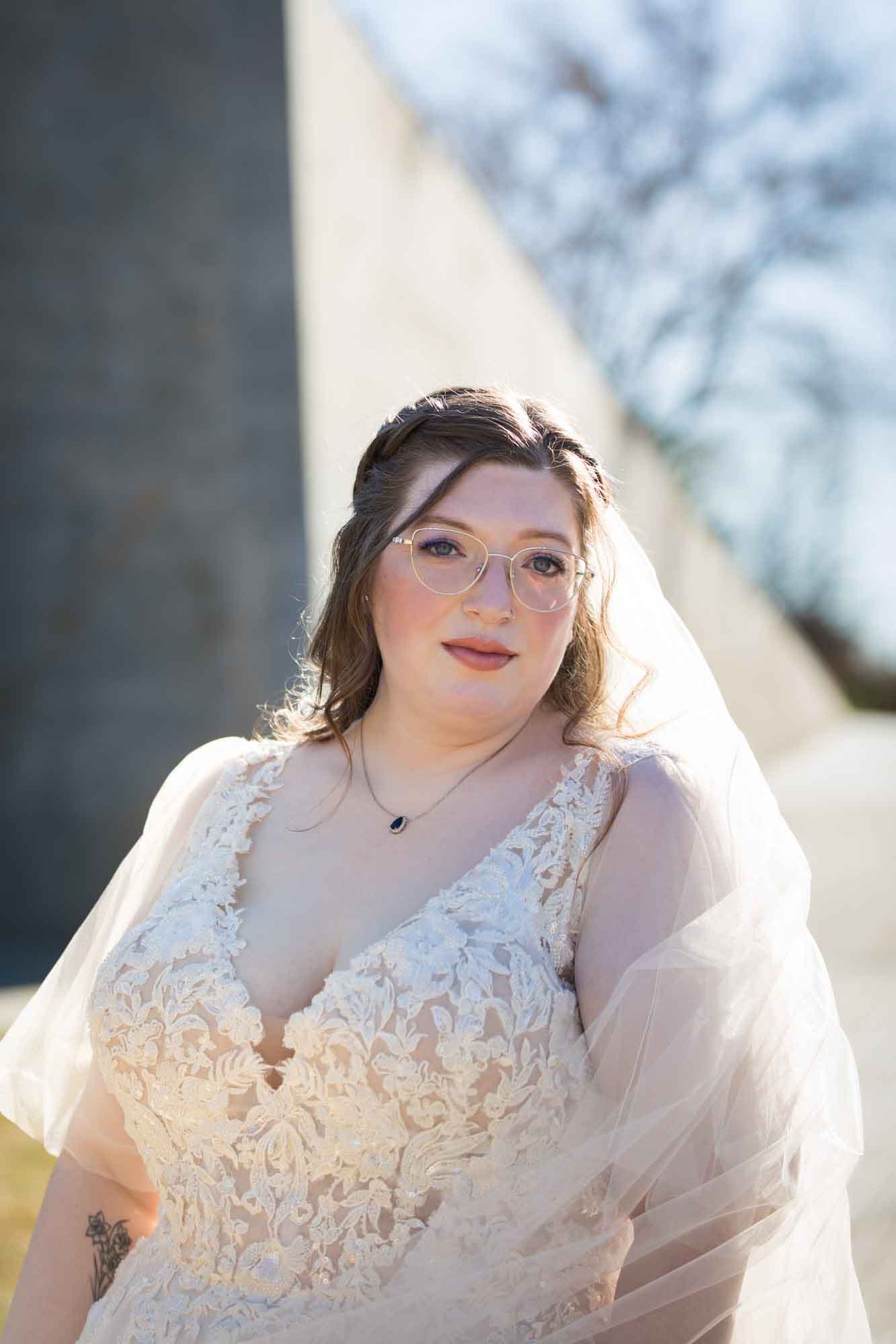 Bride wearing white dress wrapped in veil during a San Antonio Botanical Gardens bridal portrait session