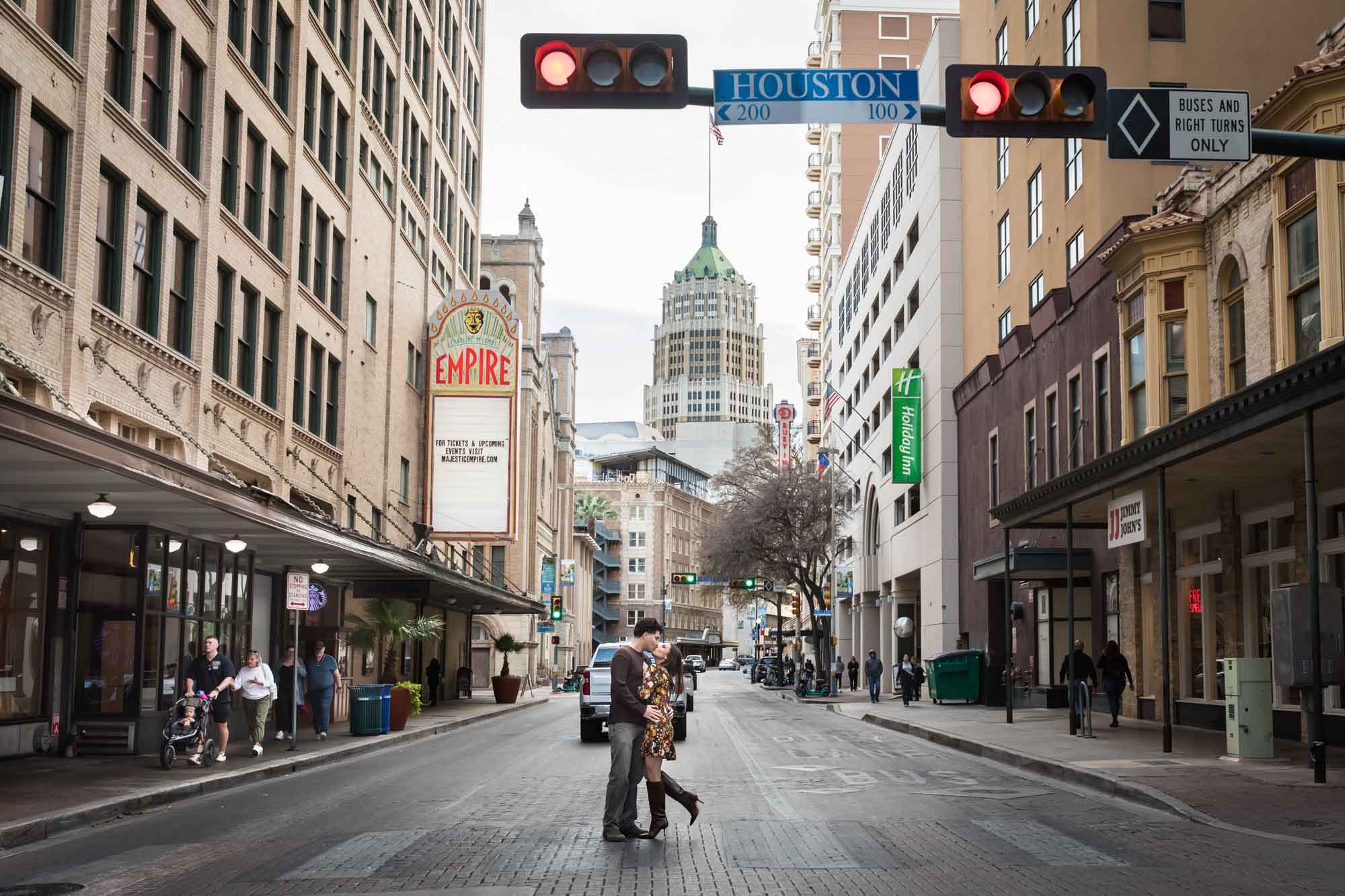Couple kissing in middle of street during a downtown San Antonio surprise proposal