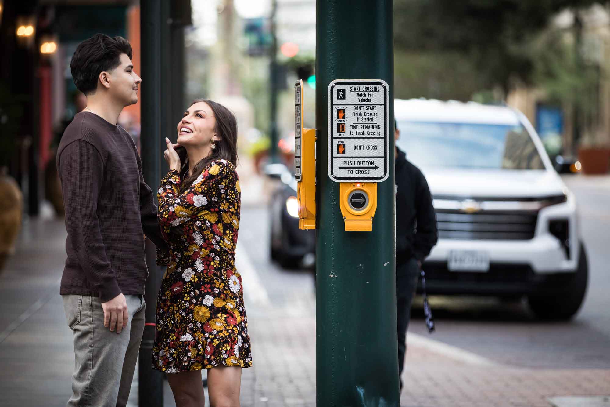 Couple standing on busy street corner during a downtown San Antonio surprise proposal