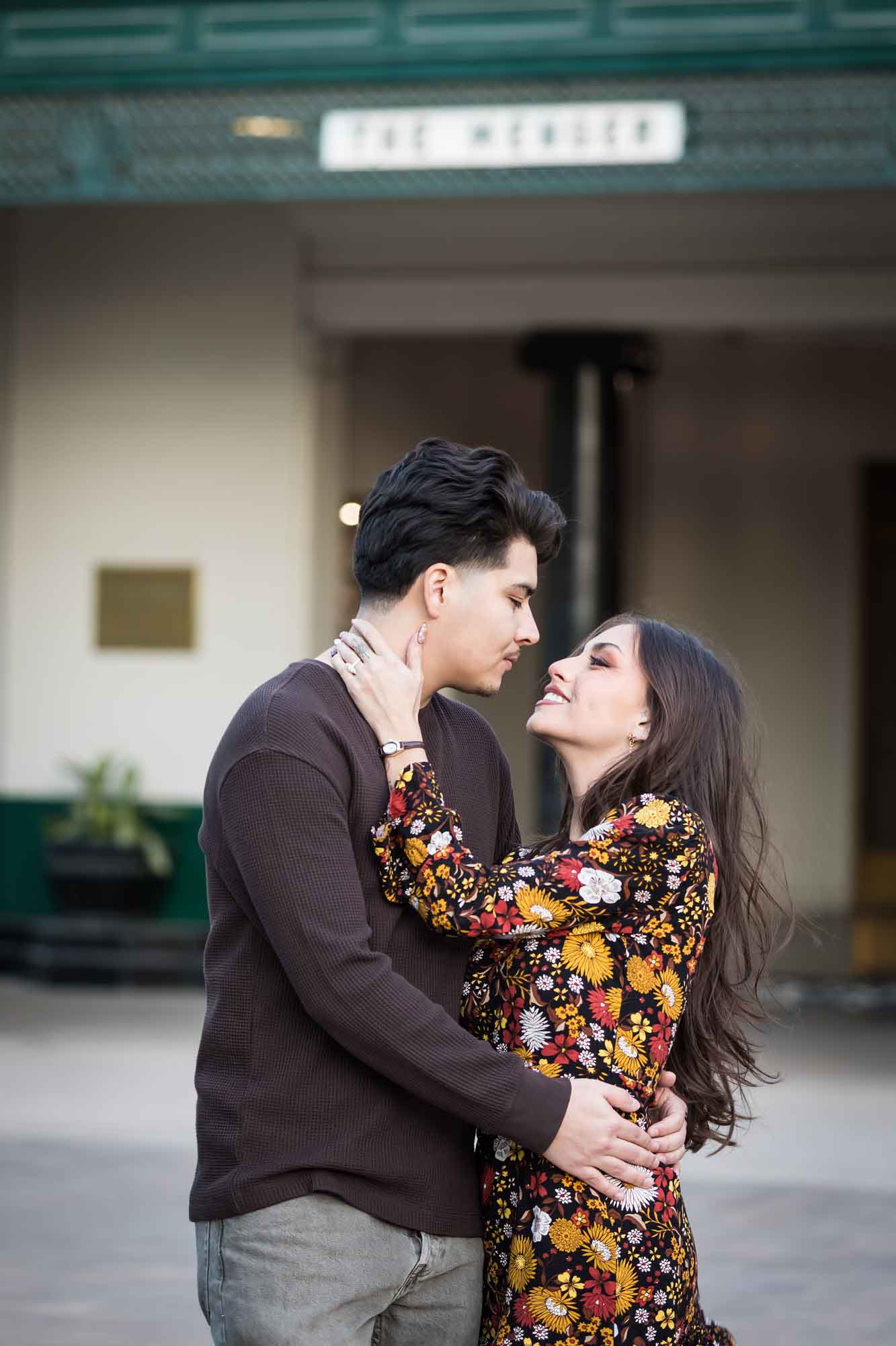 Man and woman about to kiss in front of Menger Hotel during a downtown San Antonio surprise proposal
