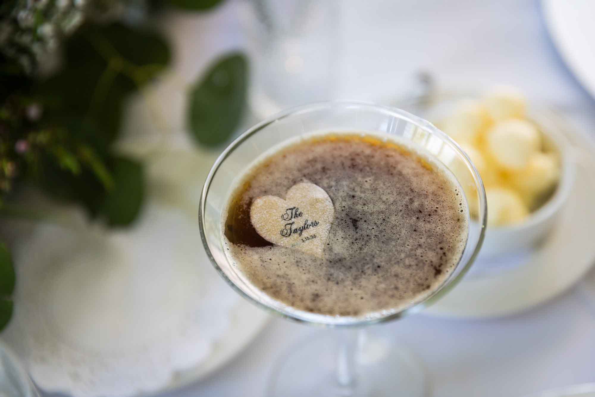 Close up on espresso martini with foam and sugar heart on table during a Guenther House wedding reception