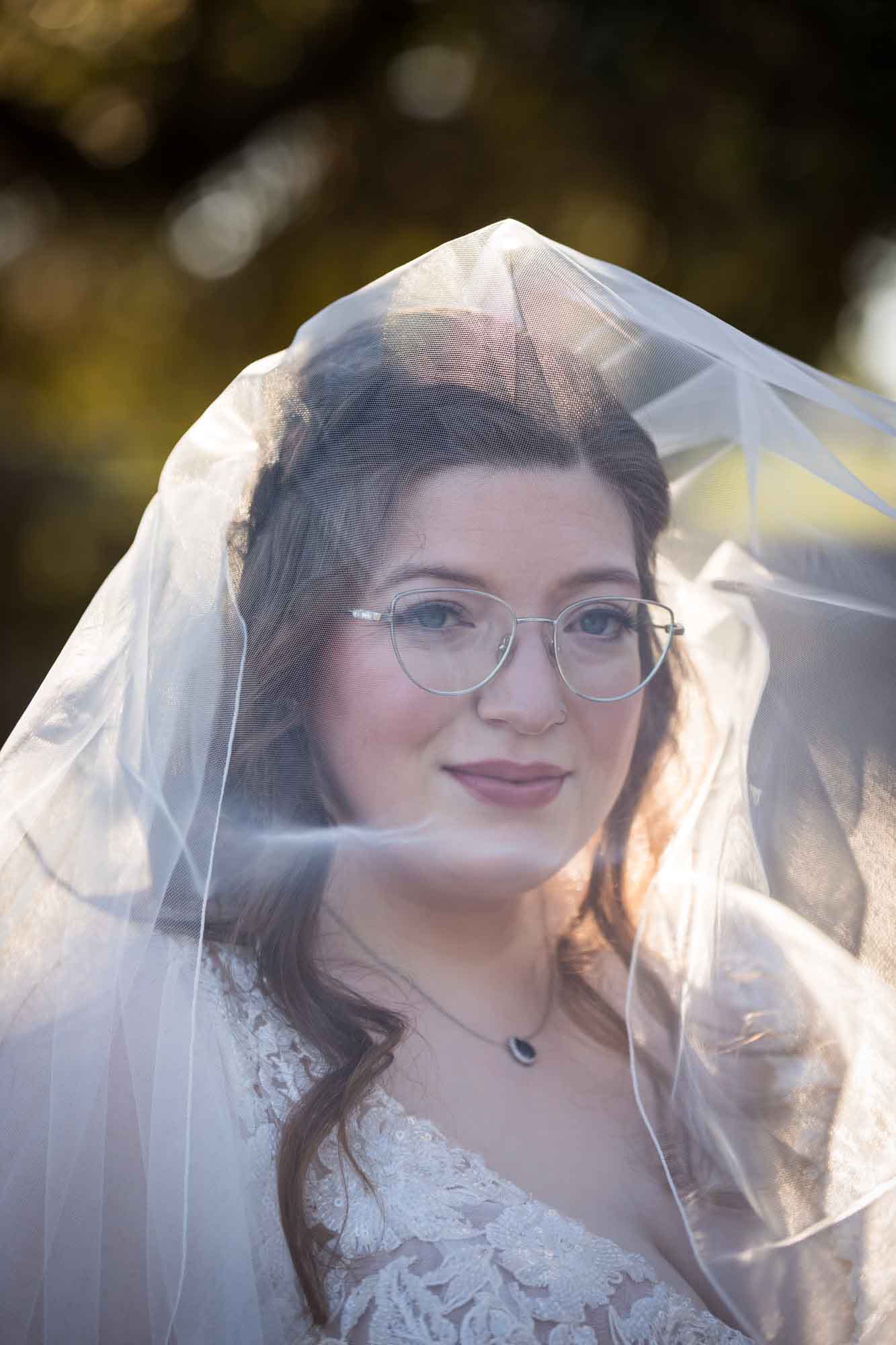 Portrait of bride underneath veil before a San Antonio Botanical Garden wedding ceremony