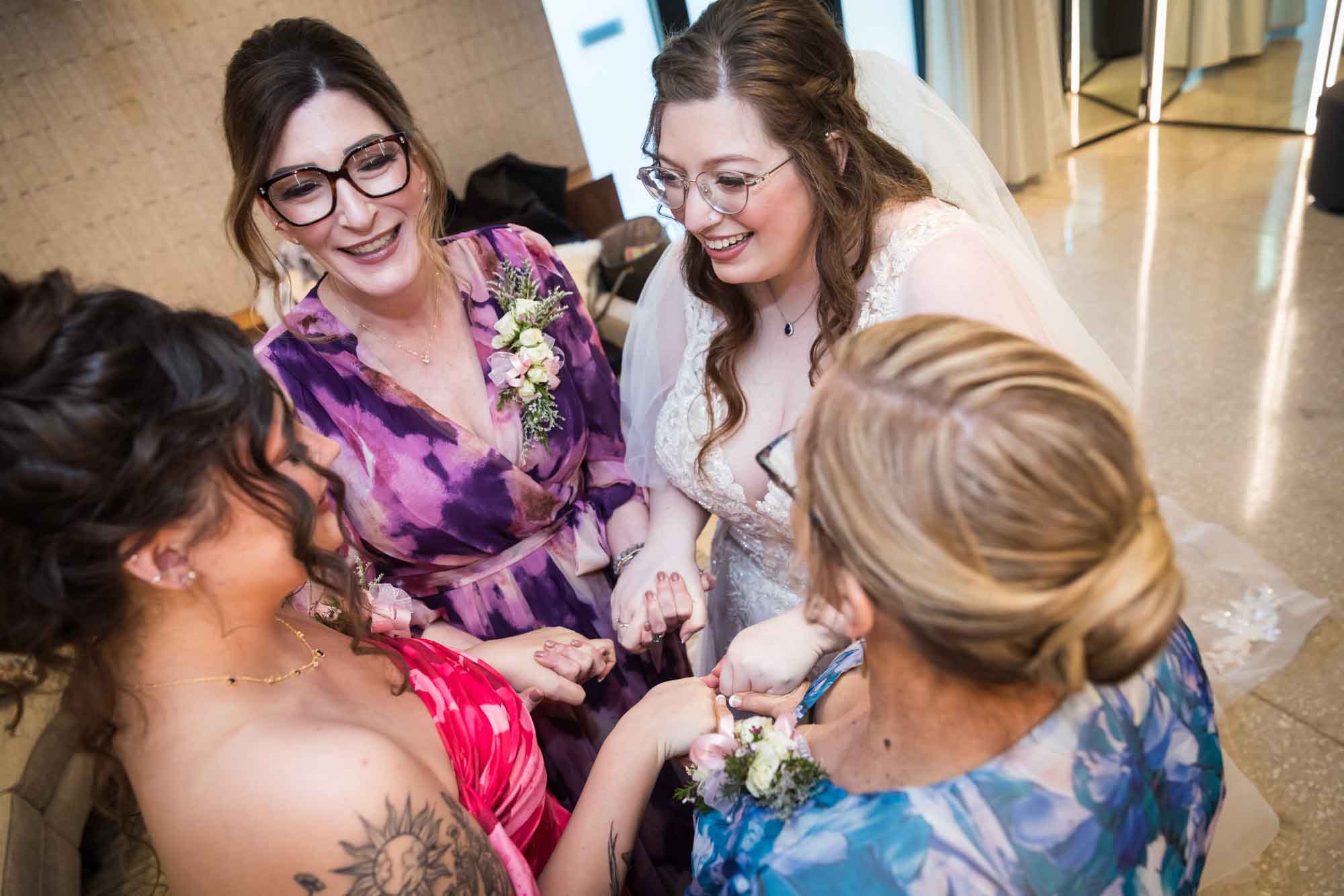 Bride holding hands with three women before a San Antonio Botanical Garden wedding ceremony