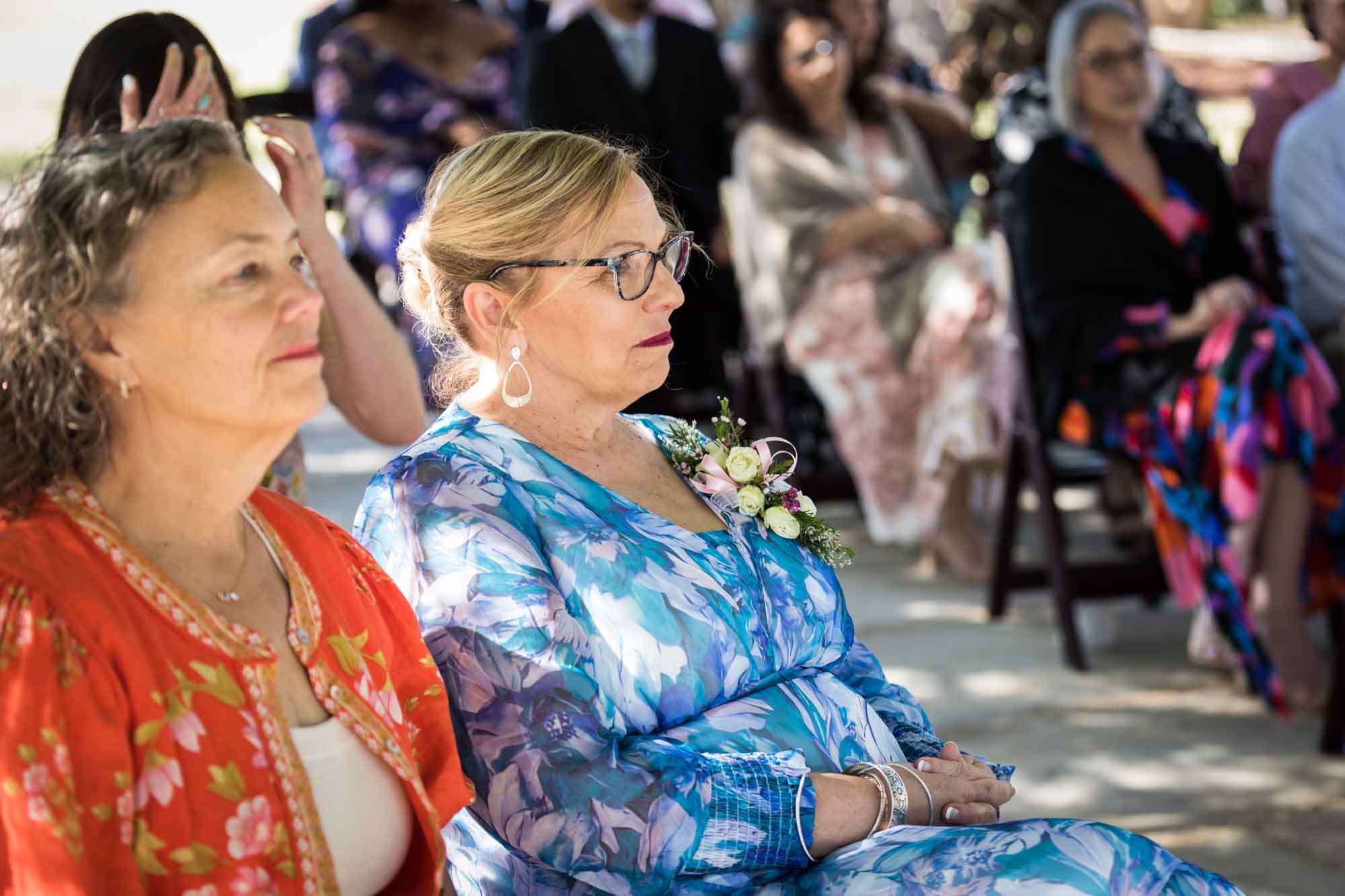 Mother and guests sitting during a San Antonio Botanical Garden wedding ceremony