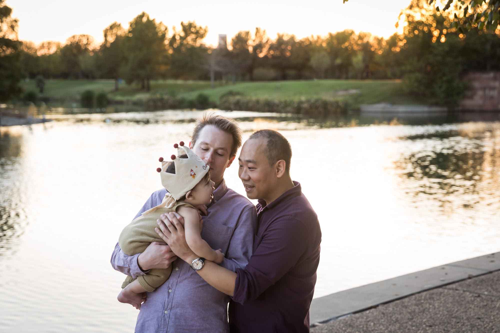 Two fathers and little boy standing beside Mueller Lake during a Mueller Lake Park family portrait