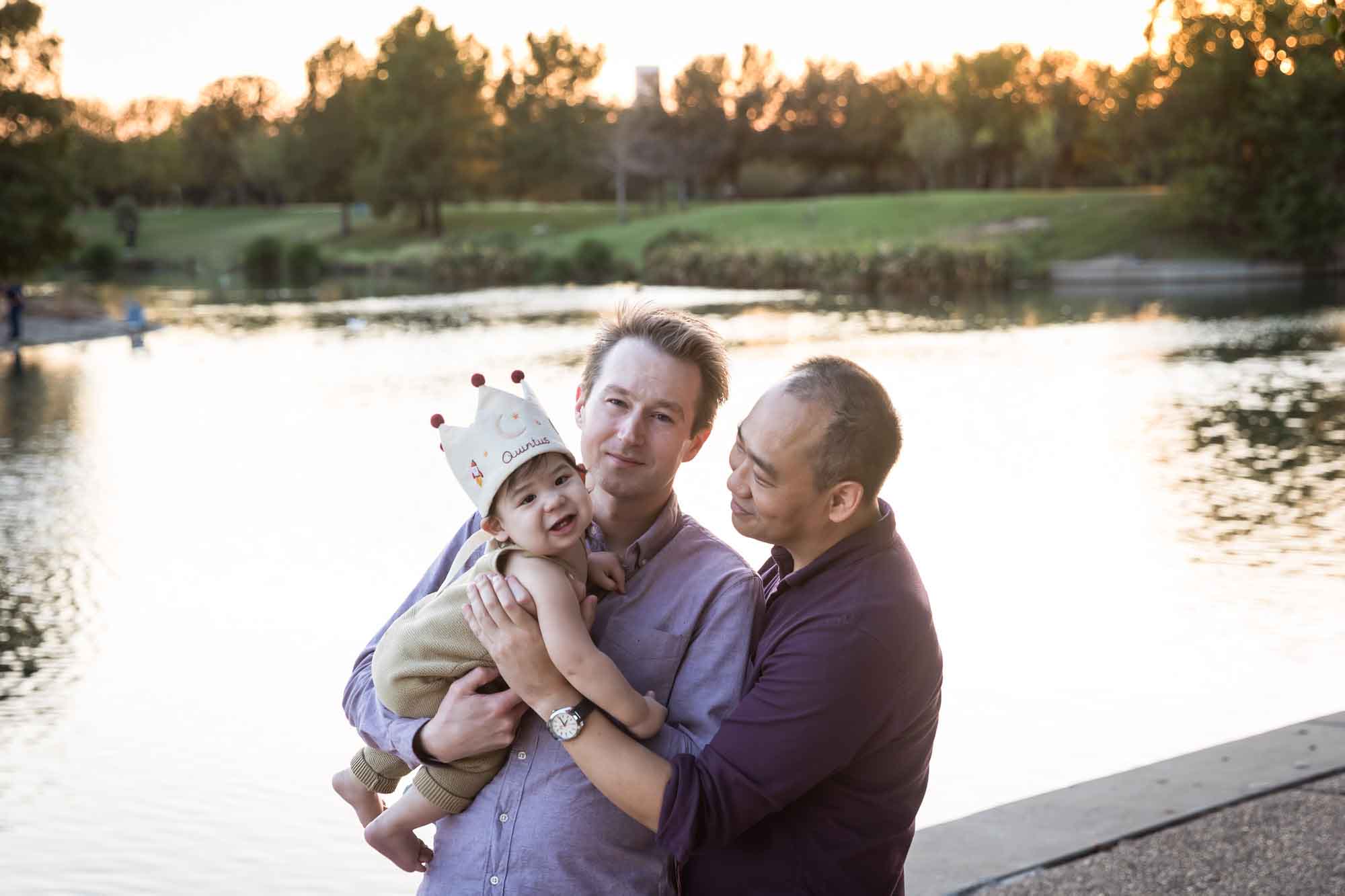 Two fathers and little boy standing beside Mueller Lake during a Mueller Lake Park family portrait